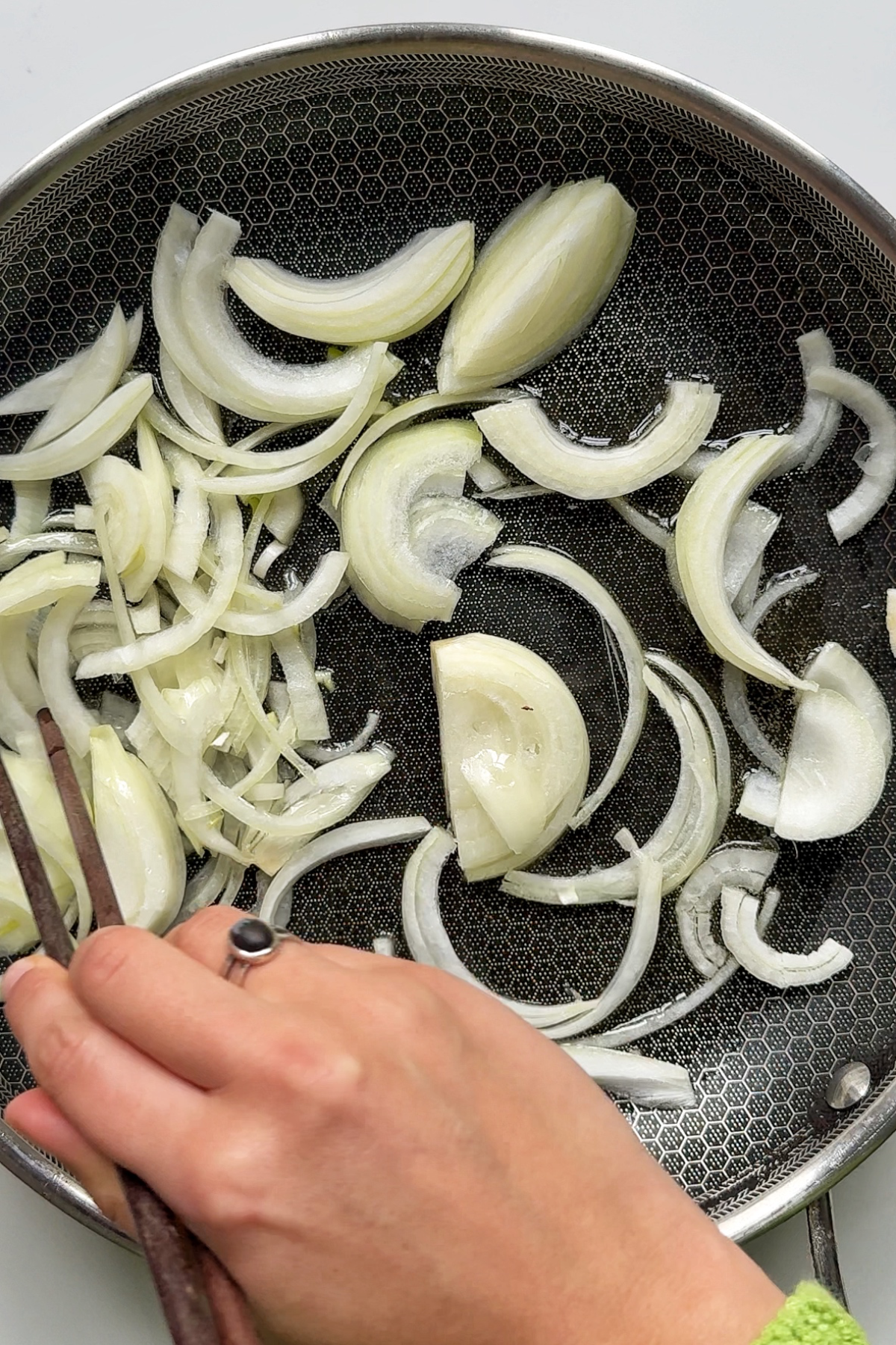 Frying onions in pan.