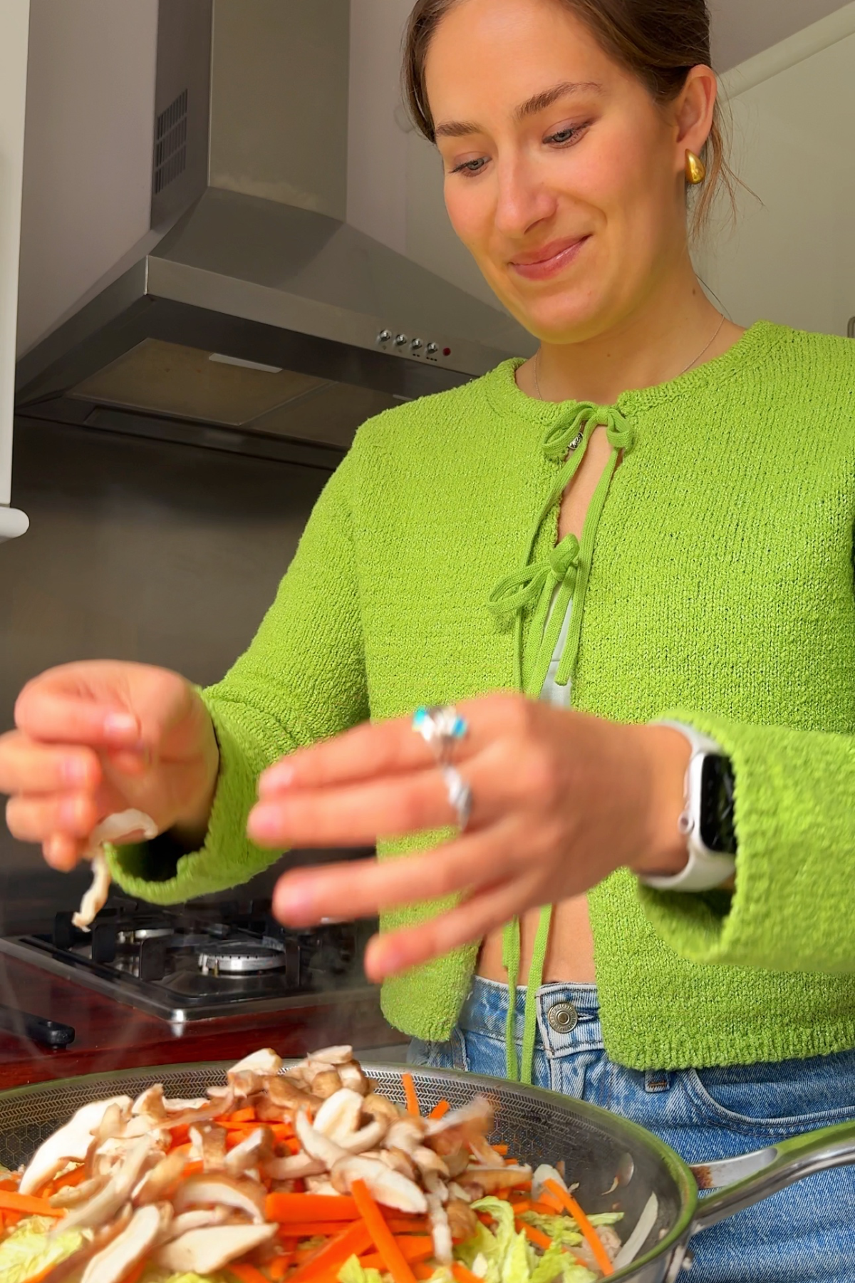 Adding vegetables to the air fryer rice paper rolls filling.