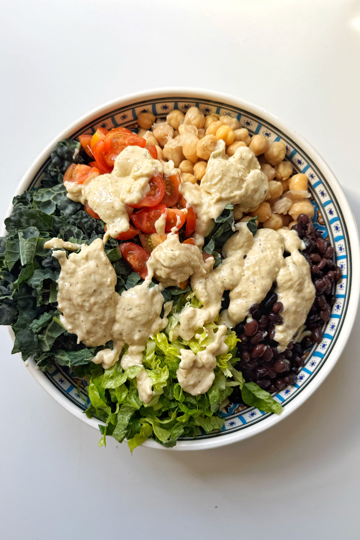 Pouring the sauce over the salad.