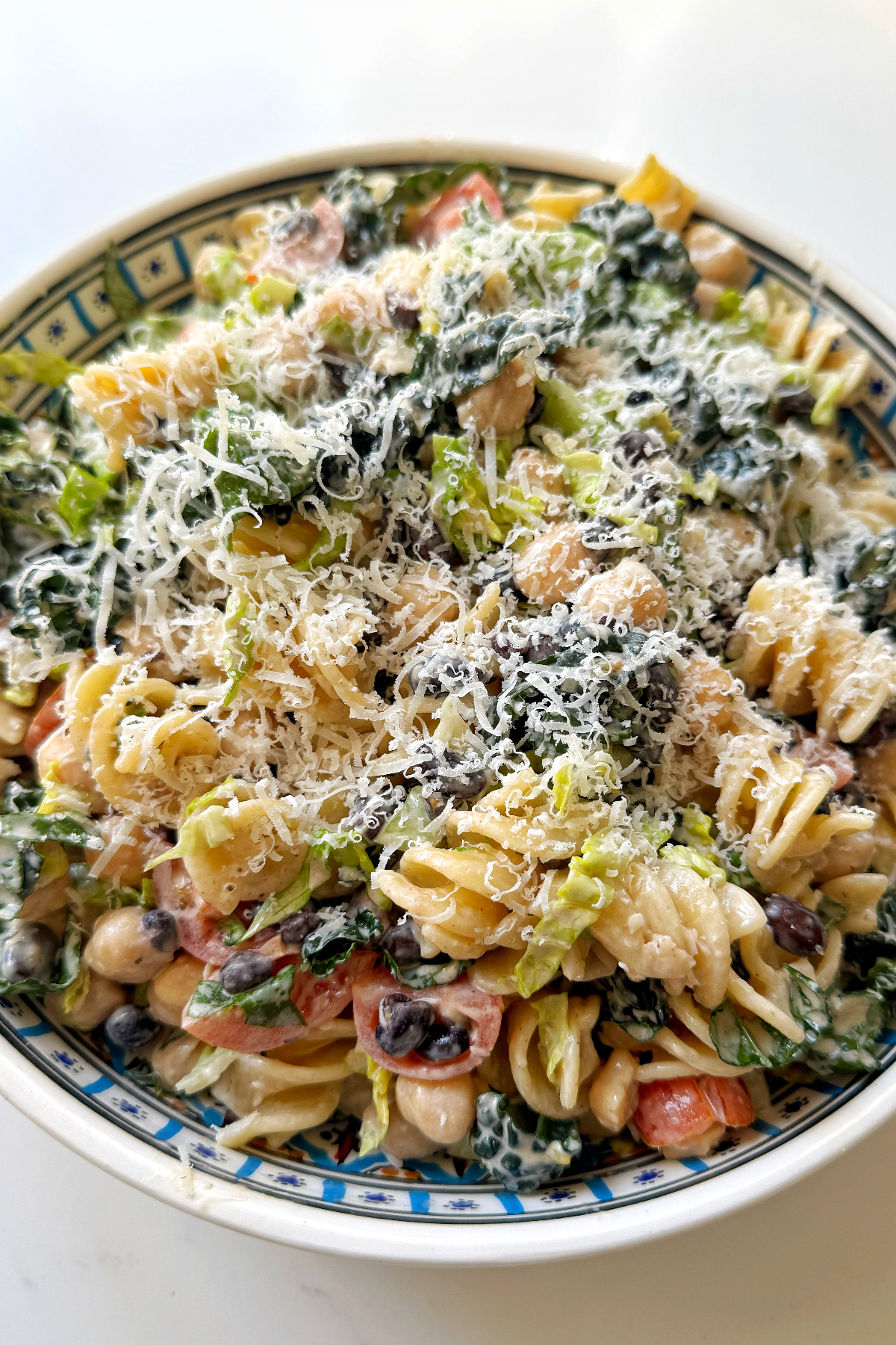 Grate parmesan over the pasta bean salad.