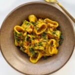 curry pasta in a brown bowl.
