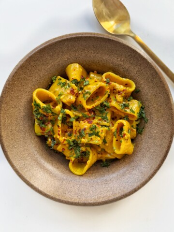 curry pasta in a brown bowl.
