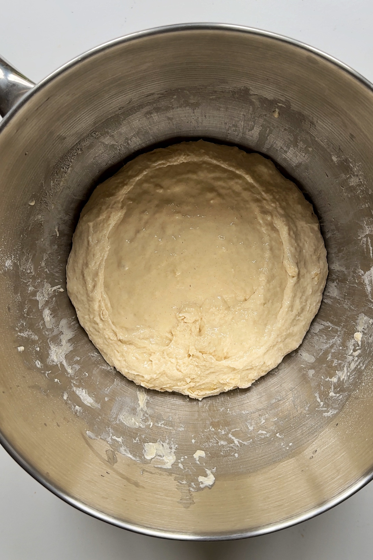 Combining focaccia dough in a bowl.