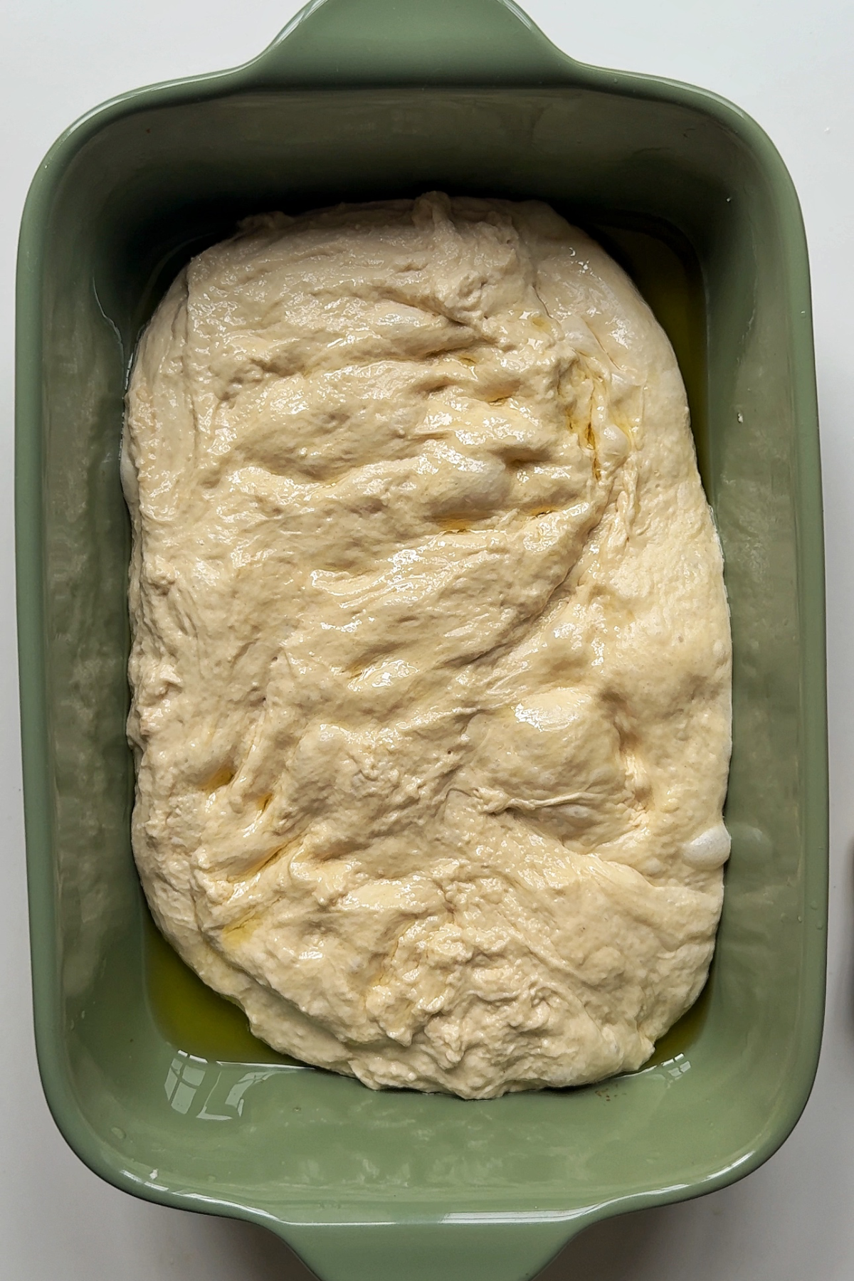 Leaving the dough to proof in a baking dish.