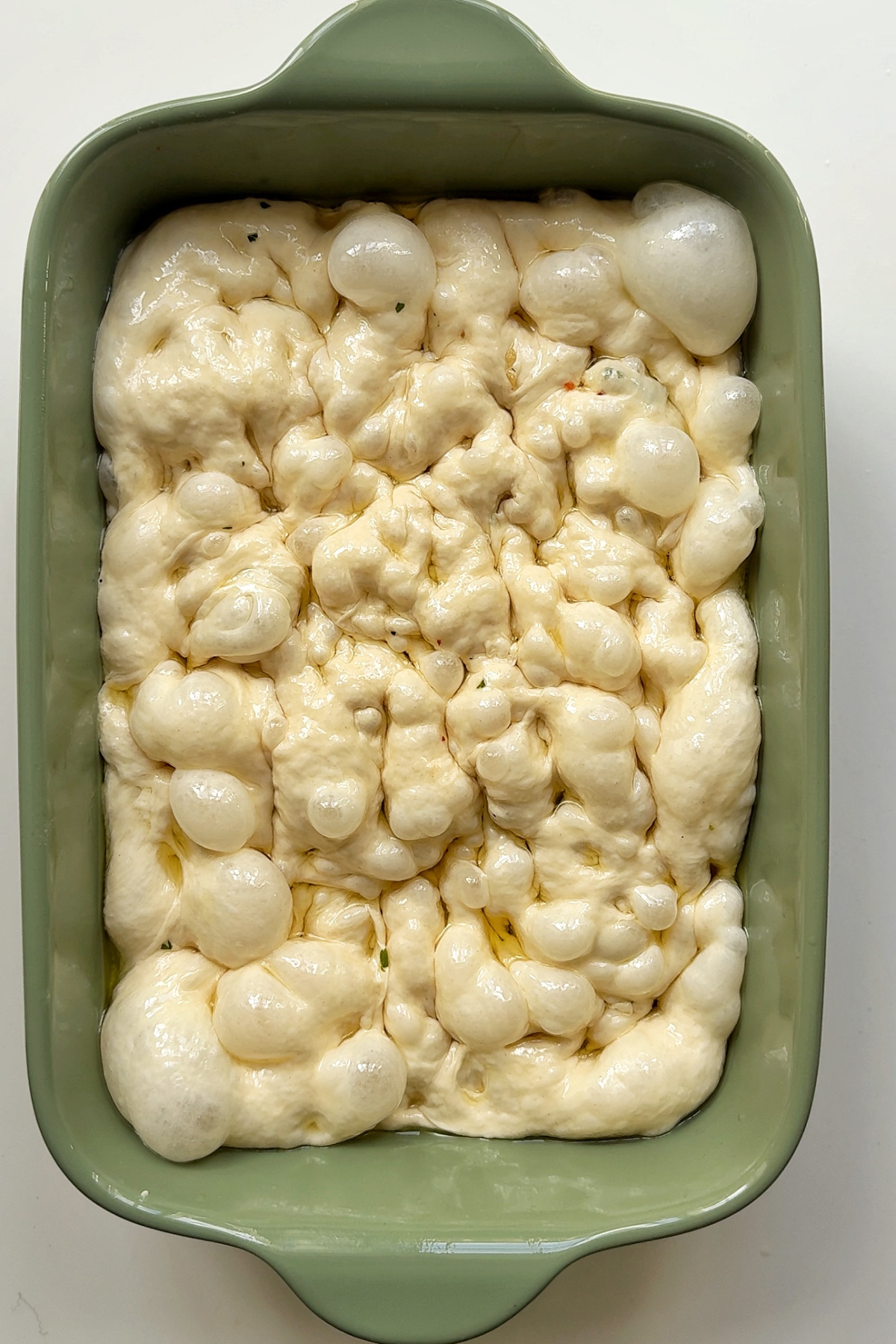 Creating dimples in focaccia dough.