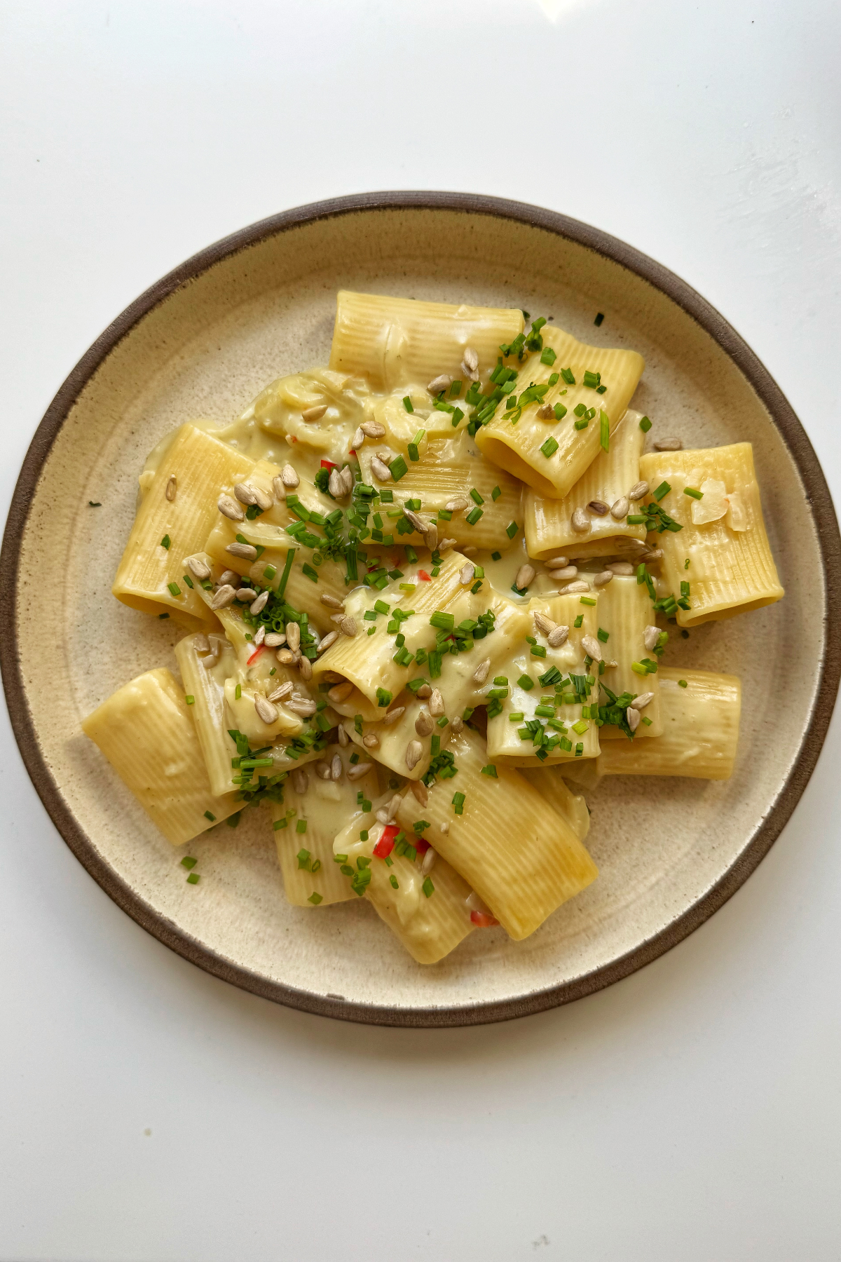 Serving up the gorgonzola pasta with sunflower seeds, chives, and hot honey.