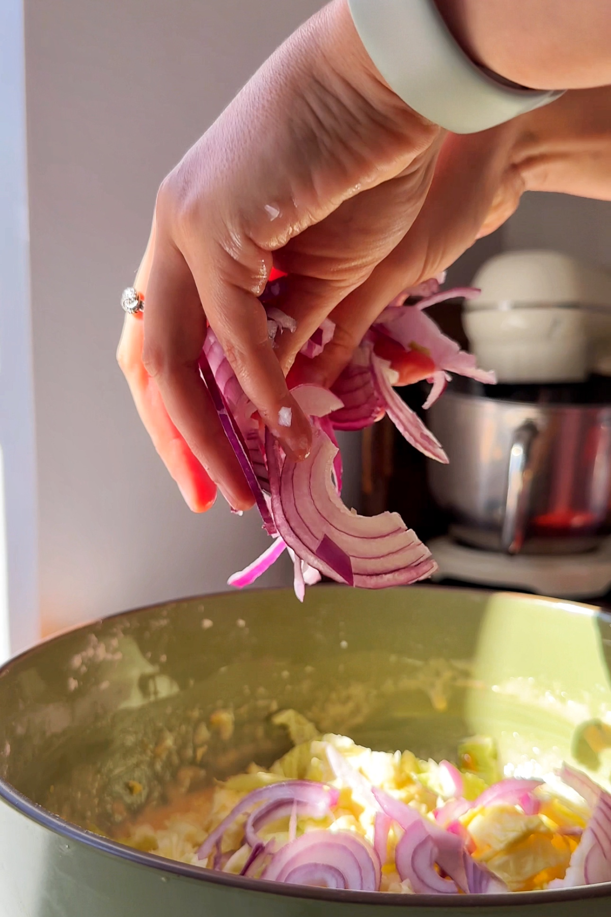 Adding onions to the batter.