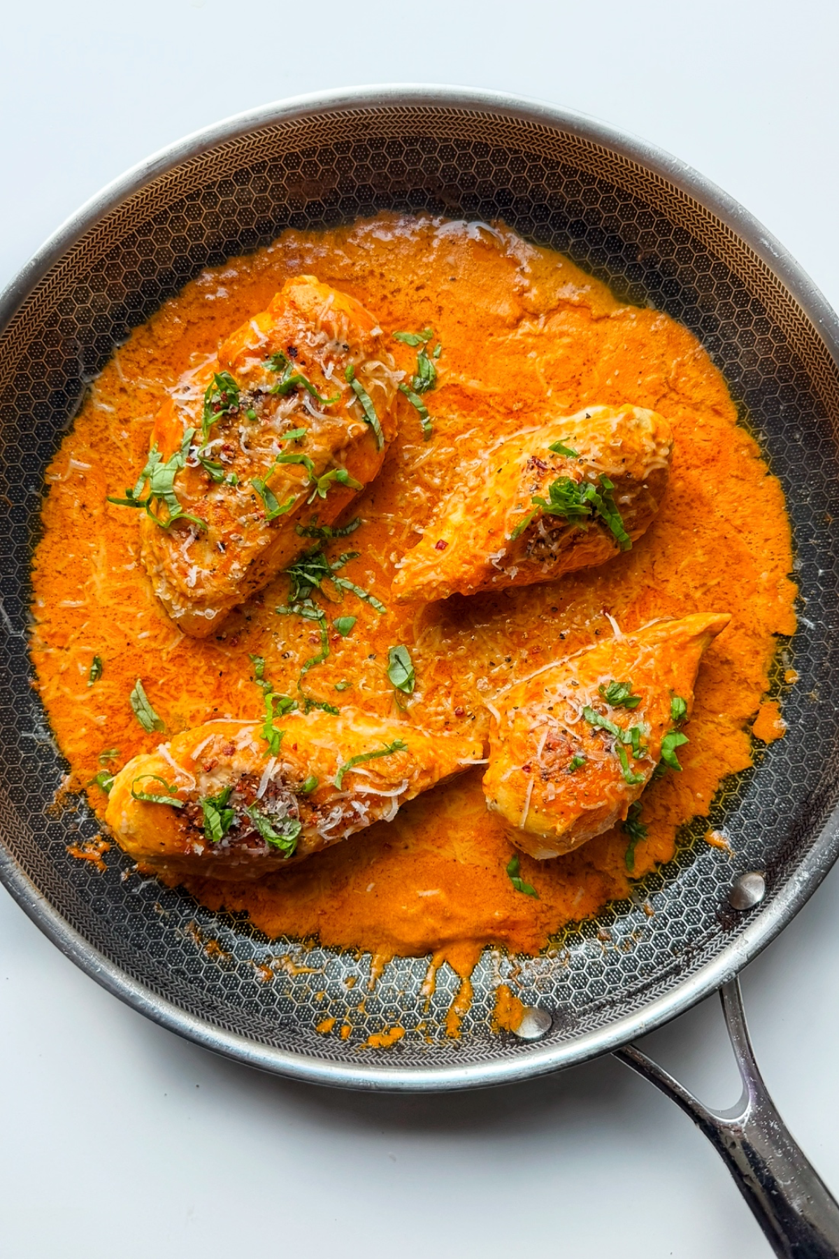 Roasted red pepper chicken in pan.