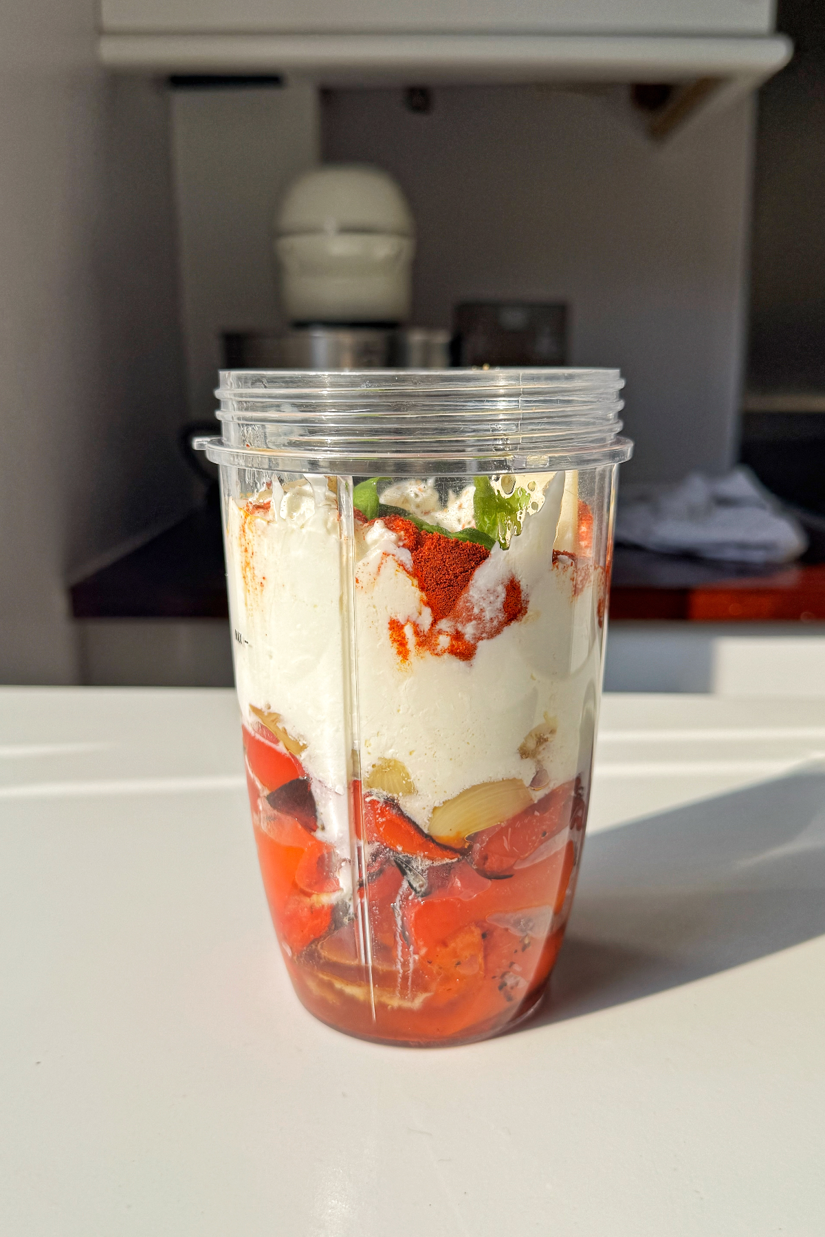 Combining the red pepper pasta sauce ingredients in a blender.