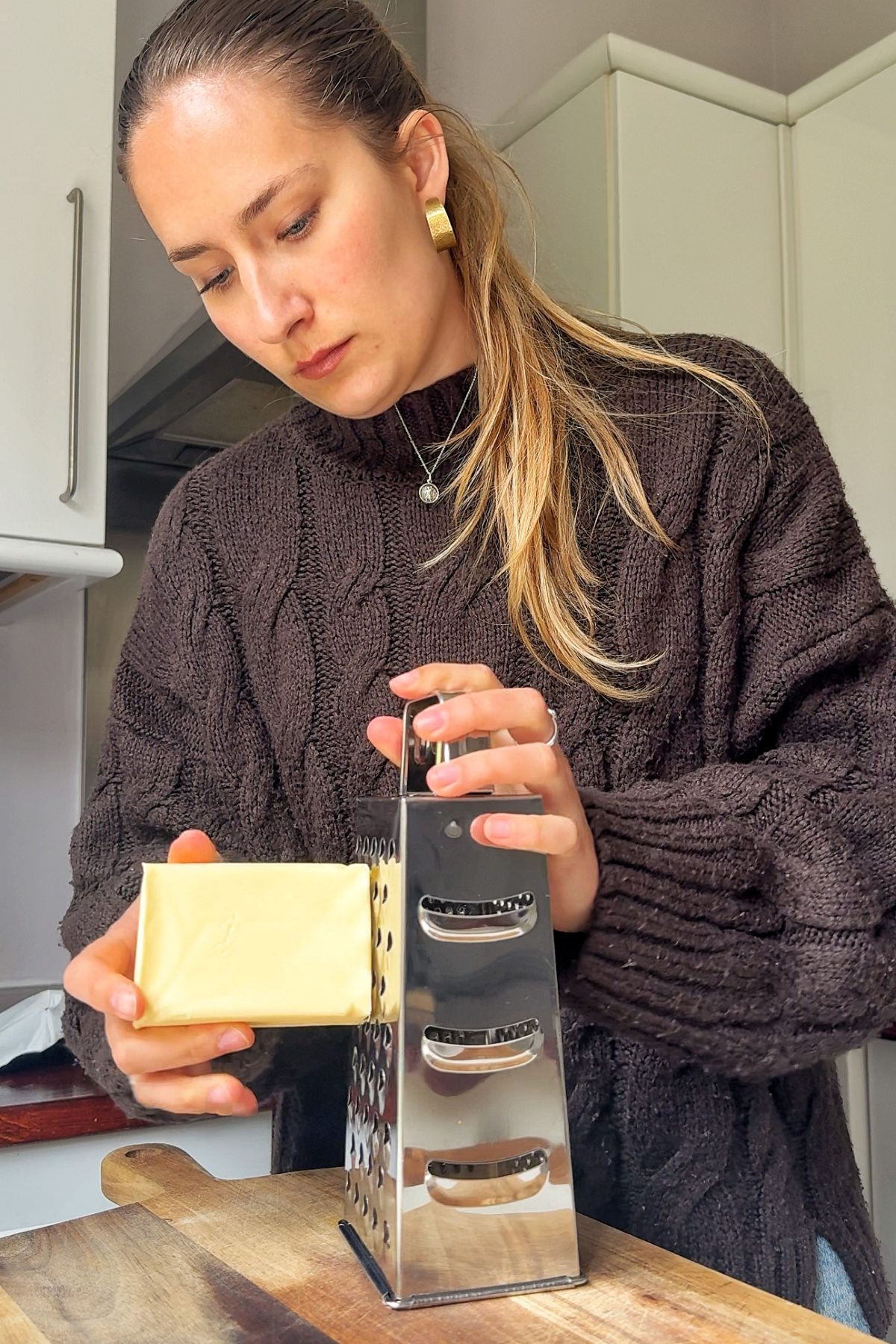 Grating frozen butter.