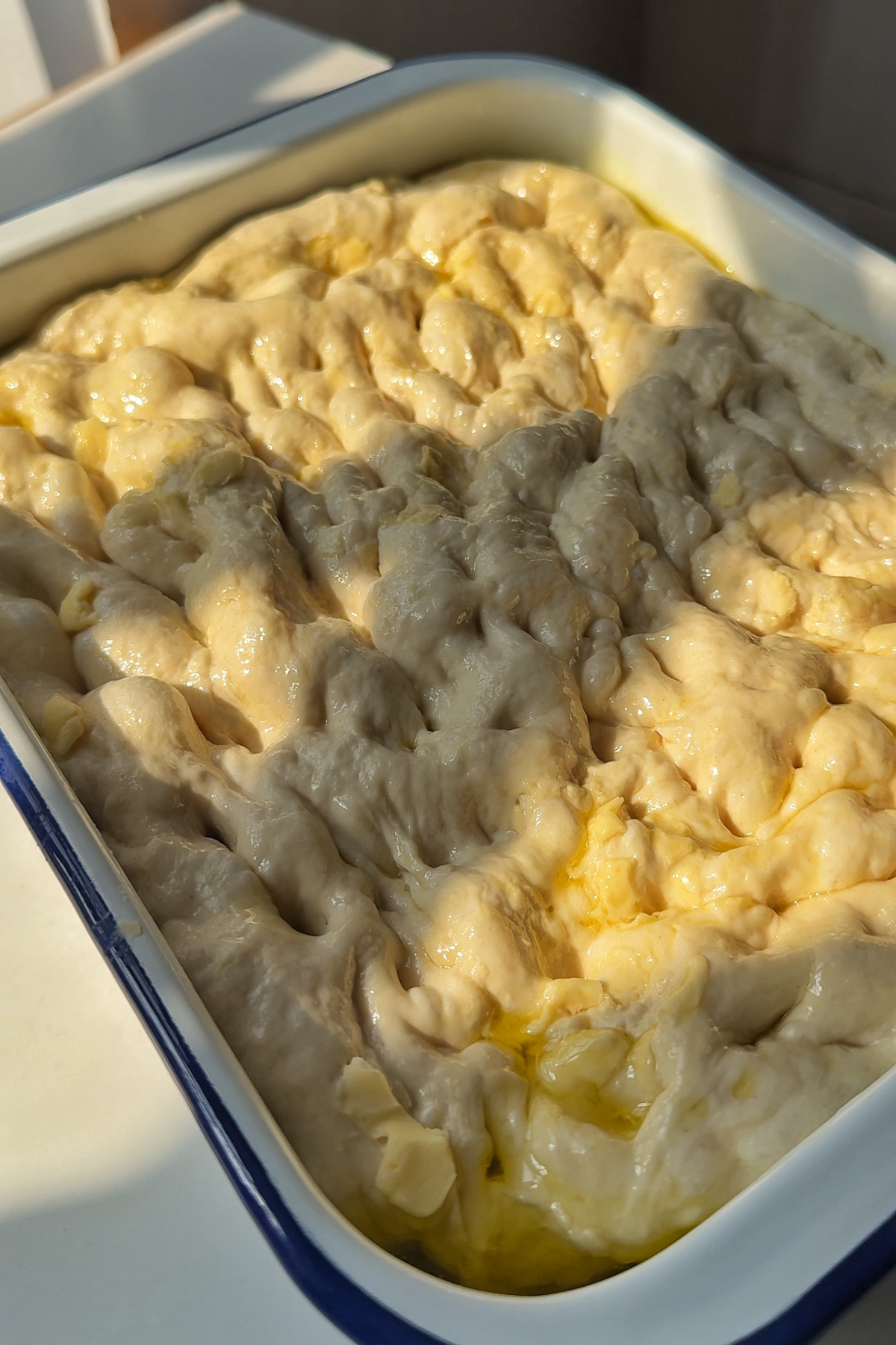 Viral croissant bread in metal tray to cook in the oven.