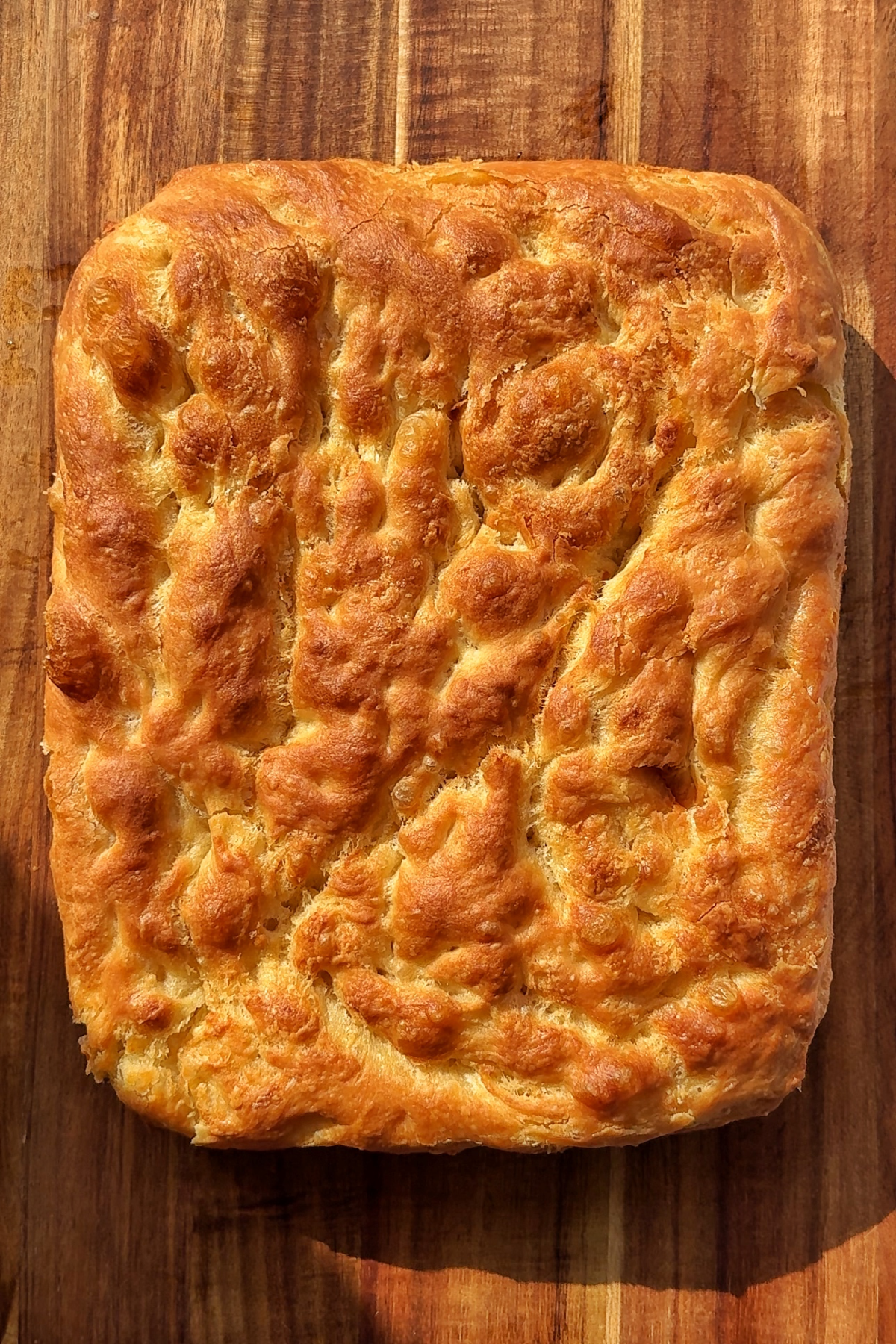 Cooked viral croissant bread in a wooden surface.