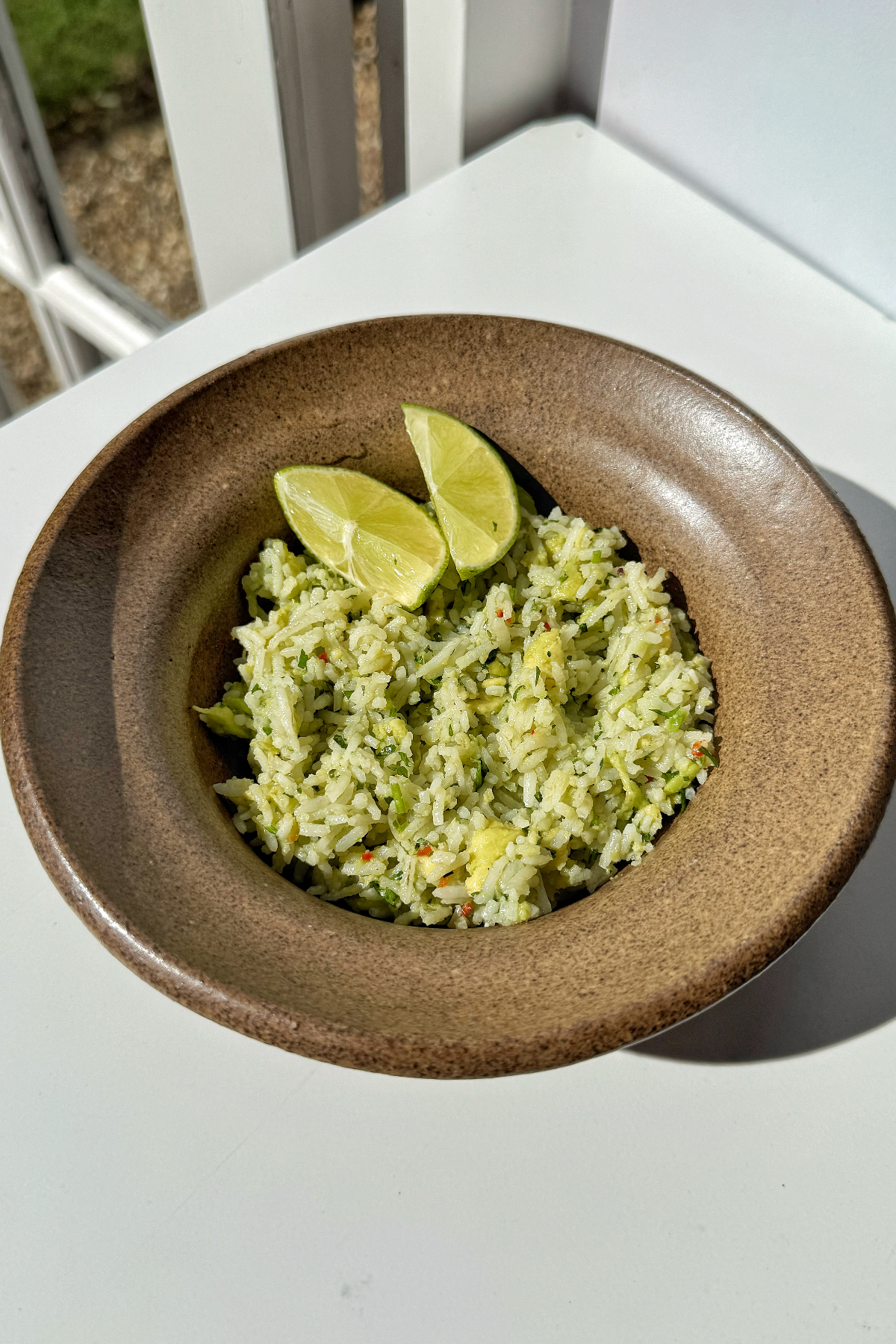 Avocado rice in brown bowl.