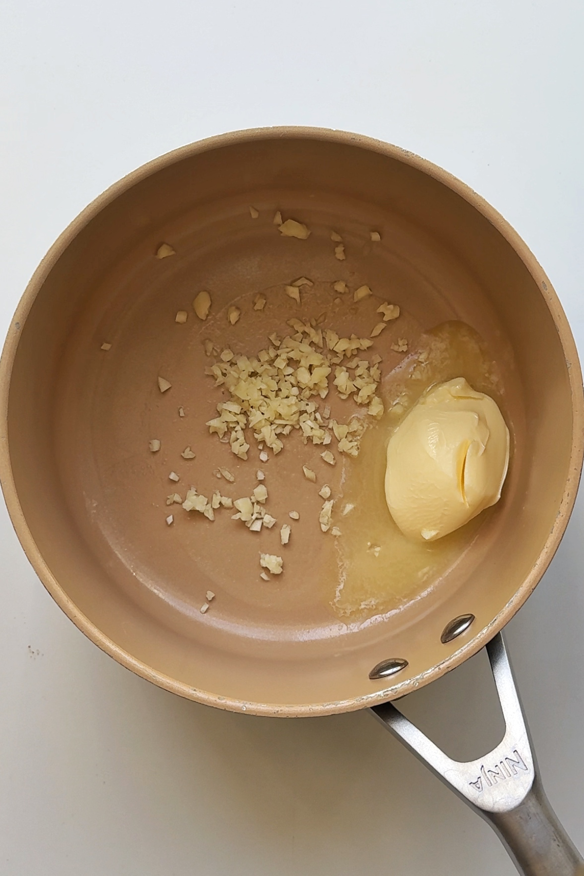 Frying butter and garlic in a saucepan.