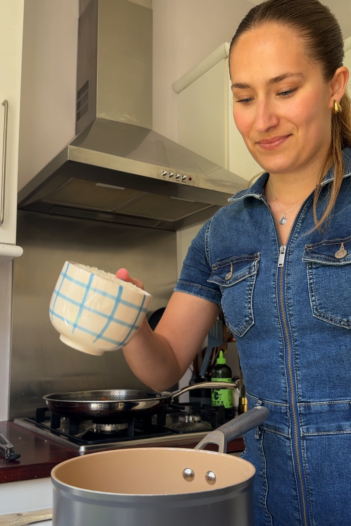 Adding rice into a pan to be cooked.