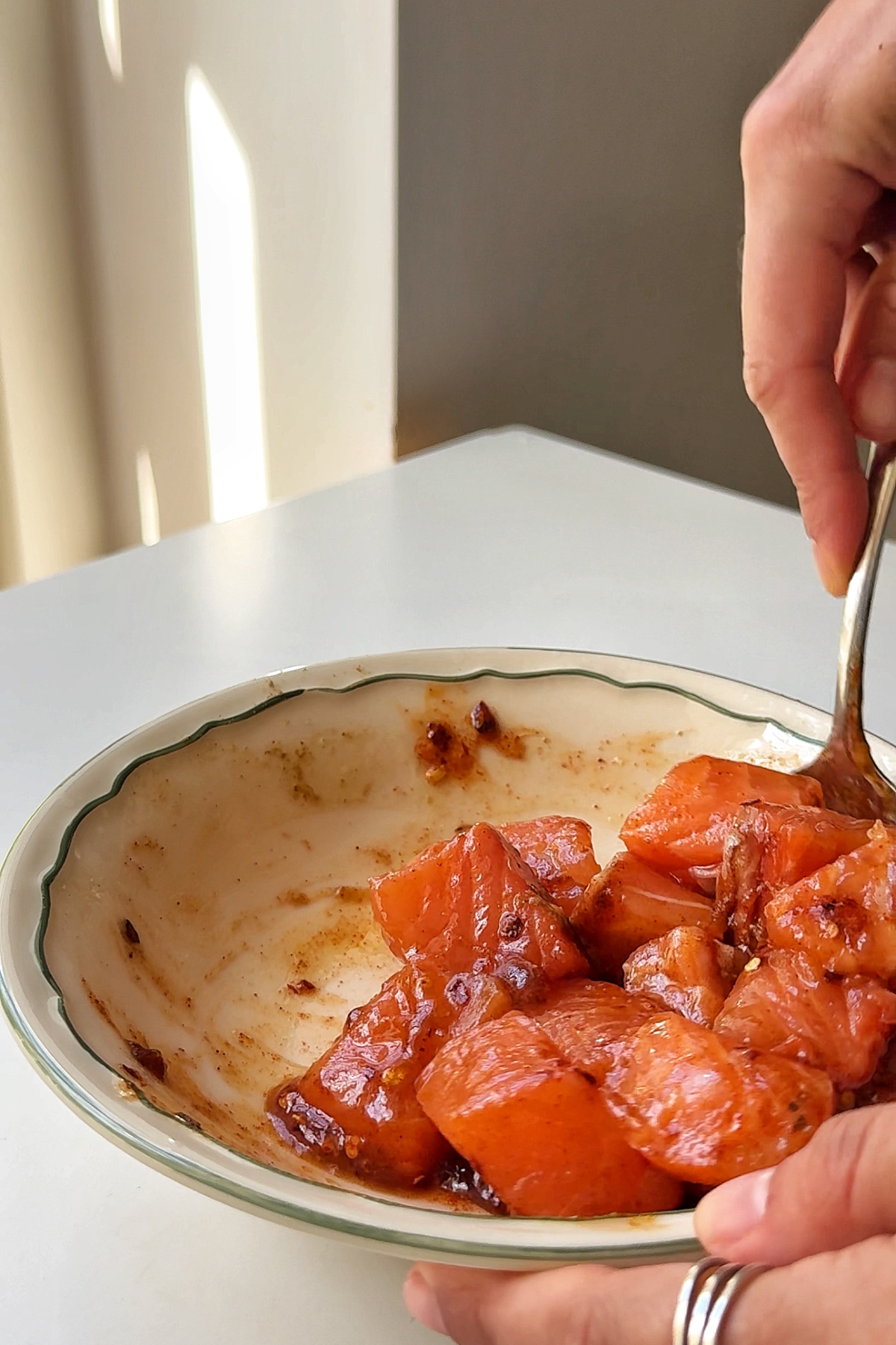 Coating the salmon in the sauce.