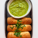 beef and cheese taquitos with an avocado sauce.