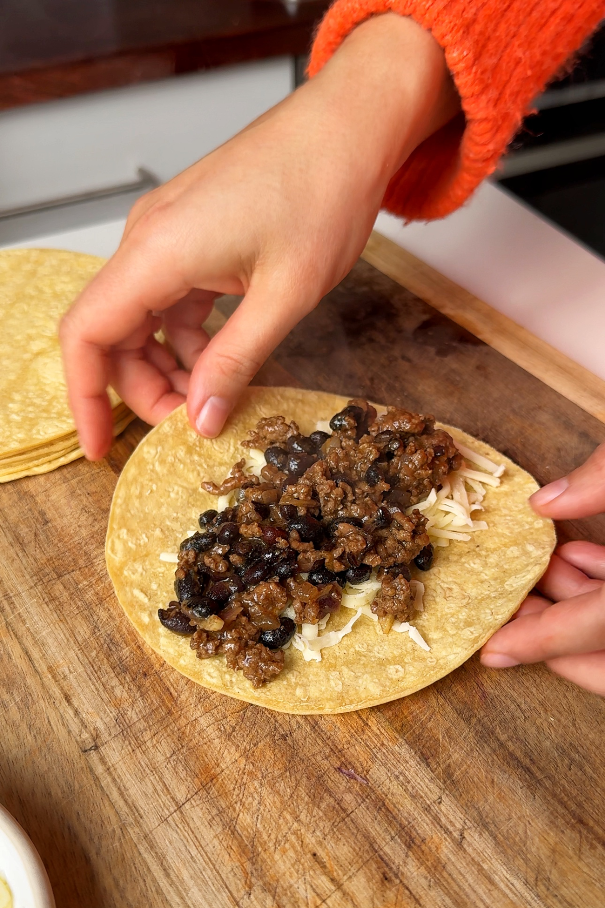 Wrapping up the taquitos in tortilla wraps.