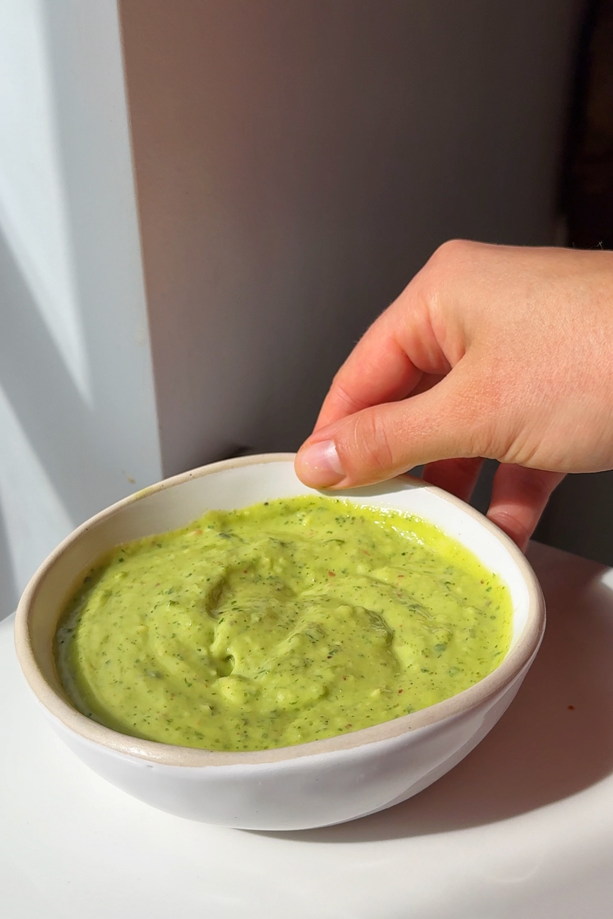 Making the avocado sauce.