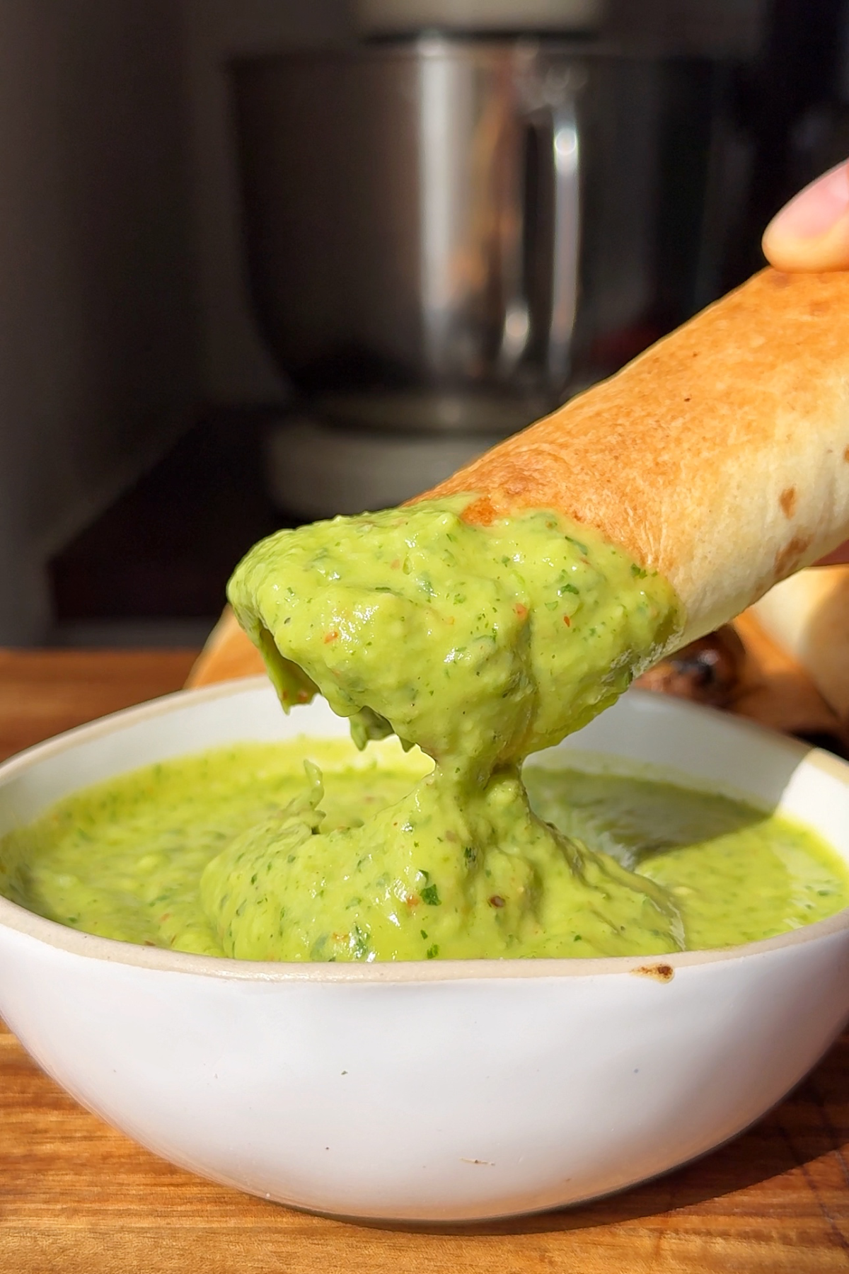 beef and cheese taquitos dipped in avocado dip.