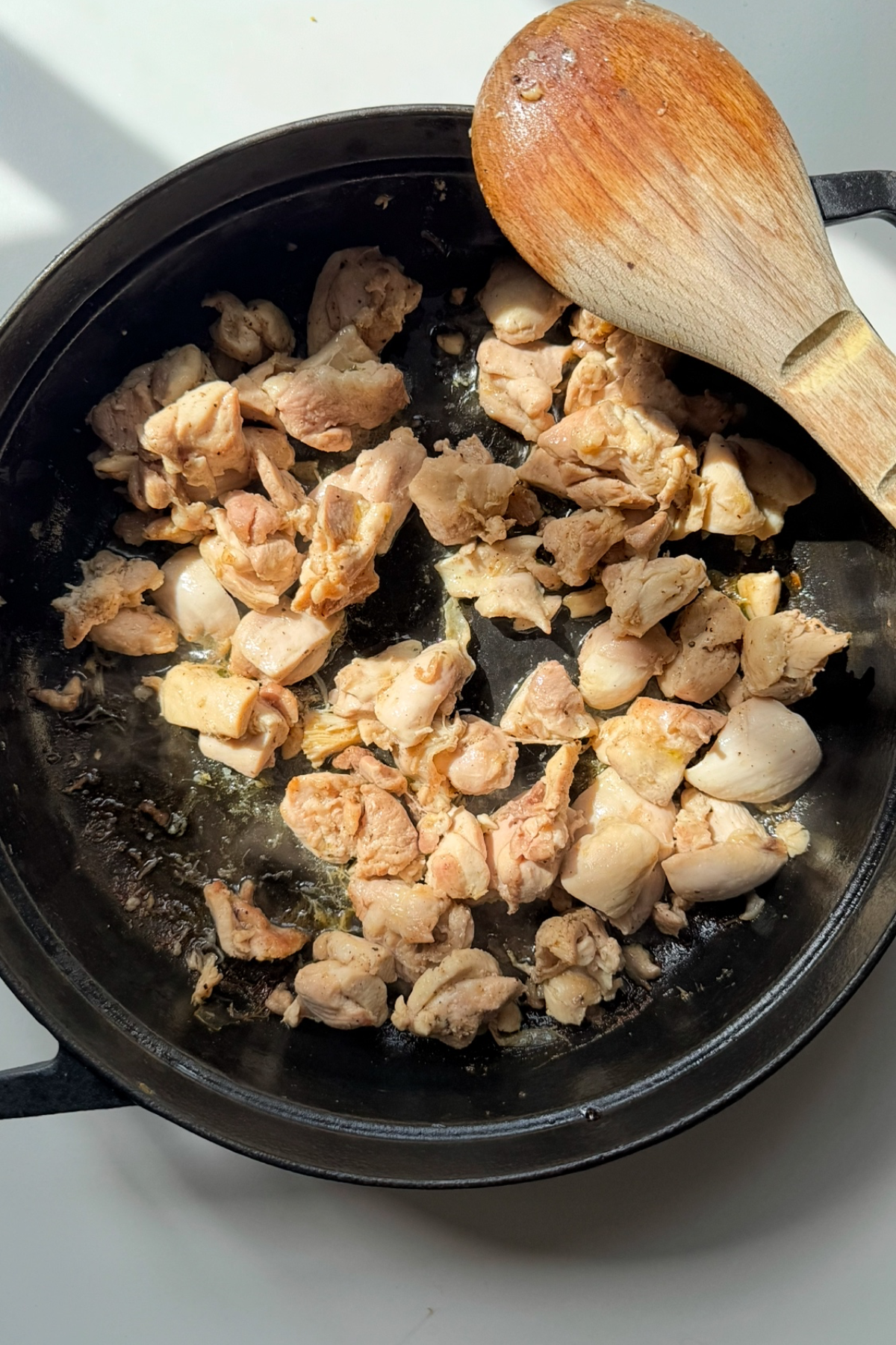 Frying chicken in a large pan.
