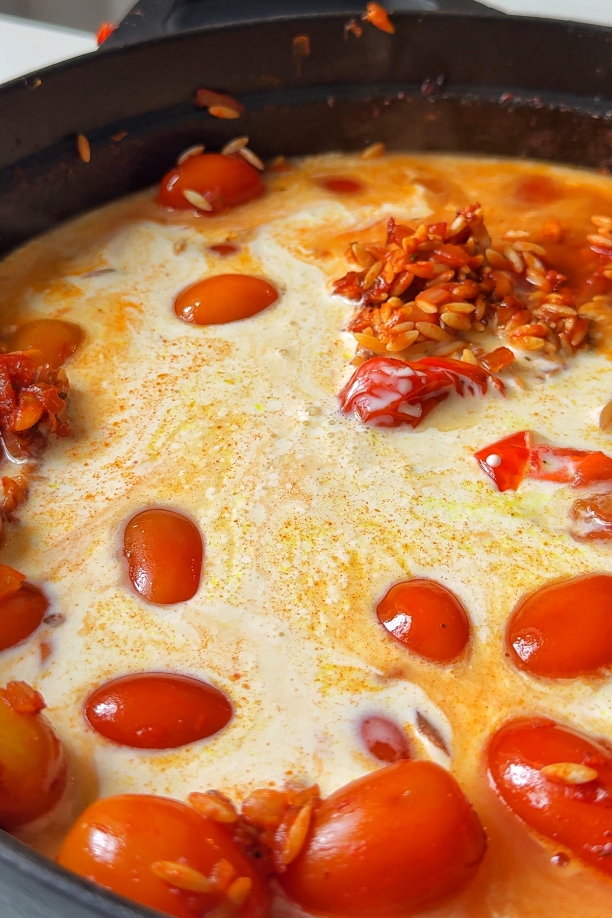Cooking the orzo in broth and cream.
