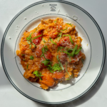 Creamy tomato orzo on a white plate.