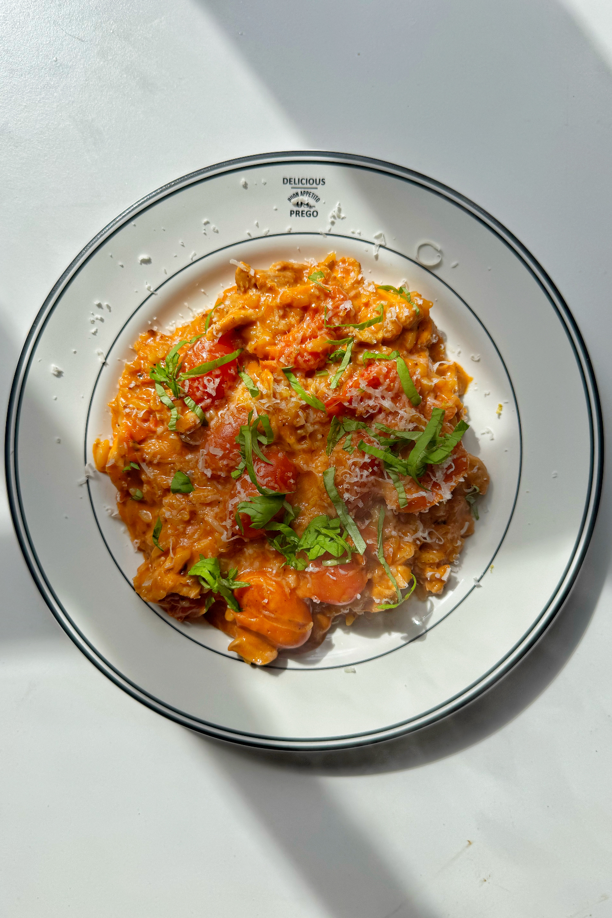 Creamy tomato orzo on a white plate.
