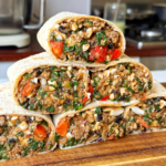 high protein breakfast burritos stacked on top of each other.