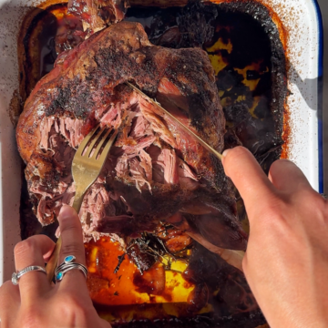 Slow roast leg of lamb in baking tray.