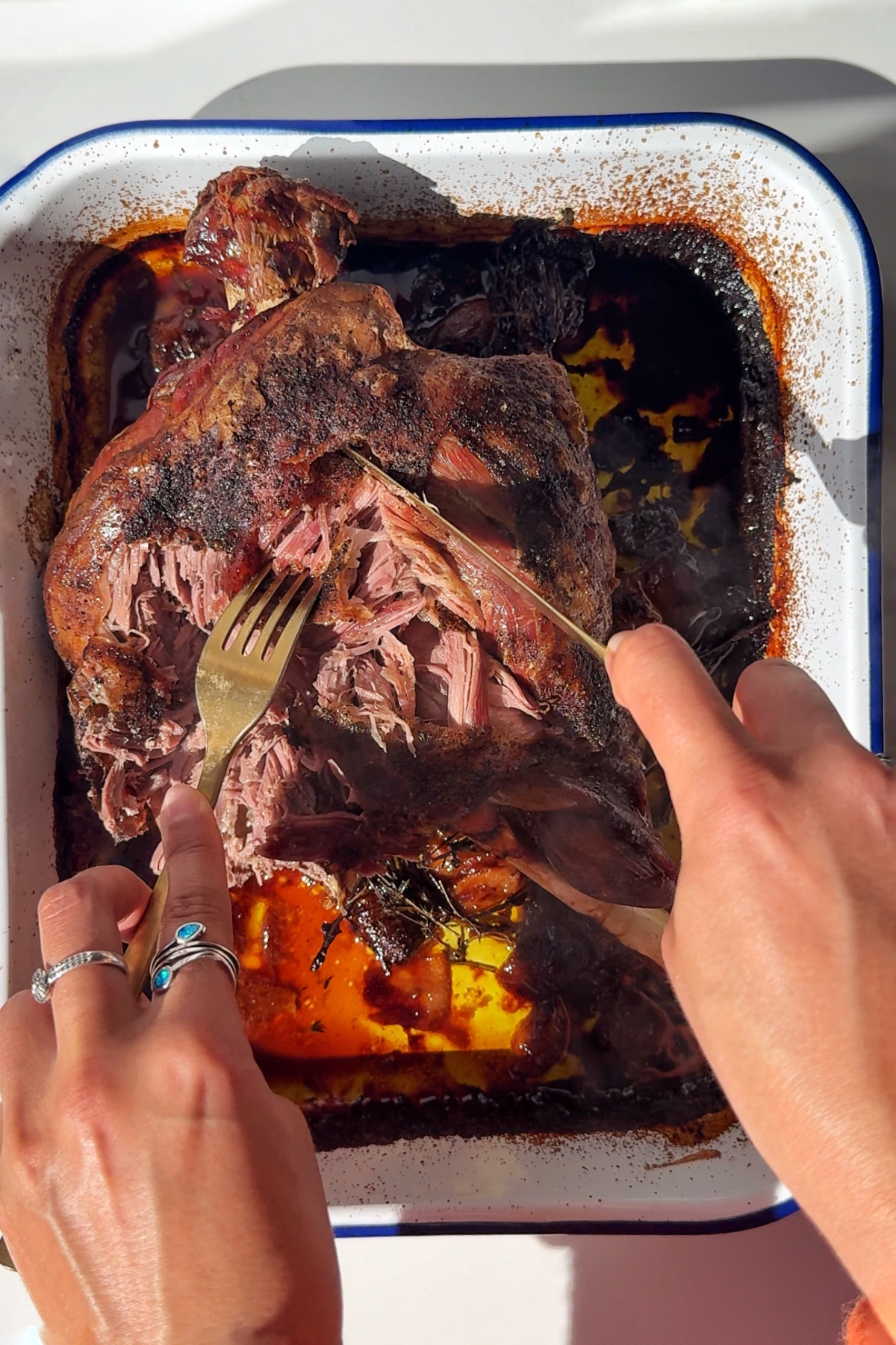 Slow roast leg of lamb in baking tray.