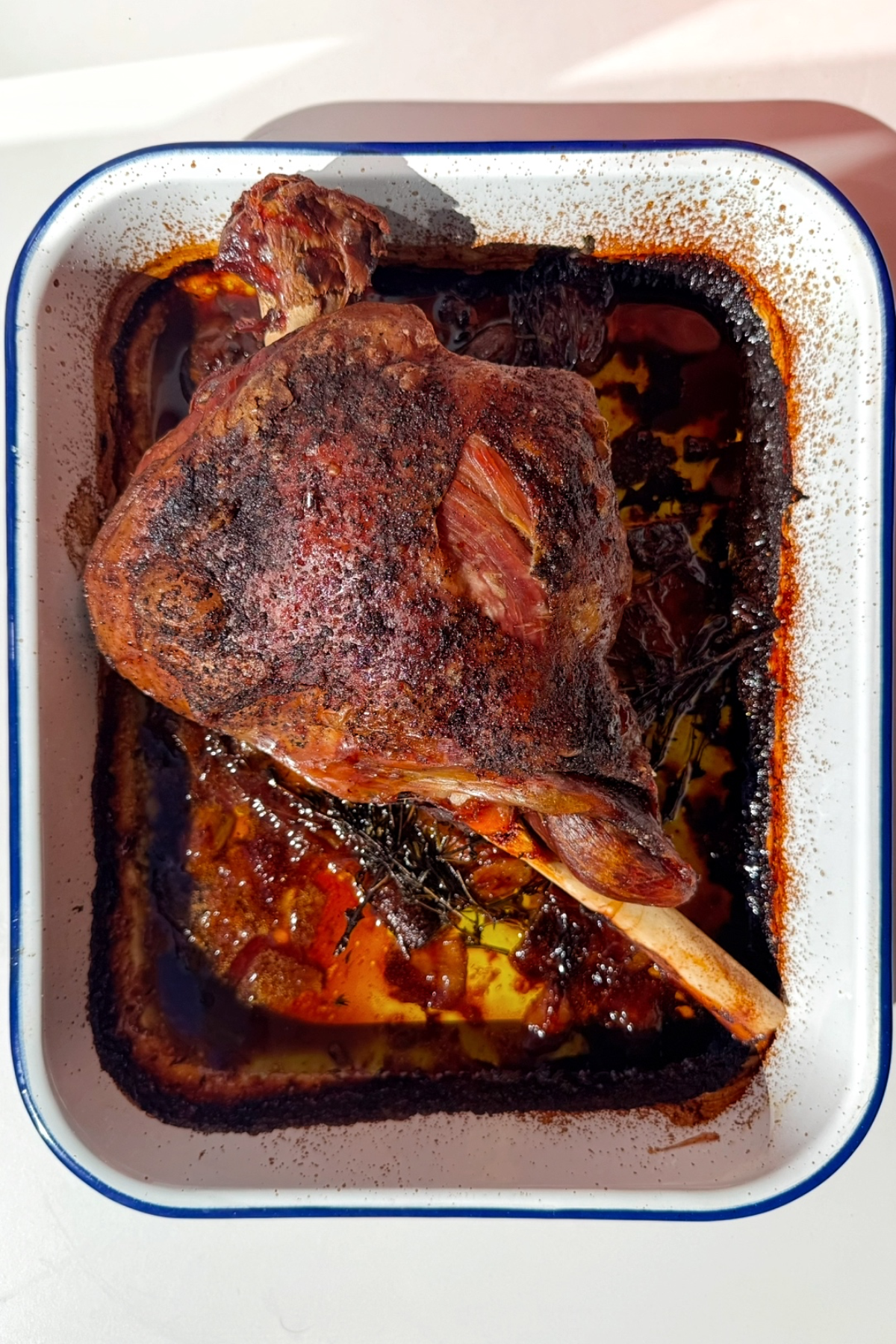 Final roast leg of lamb in tray.