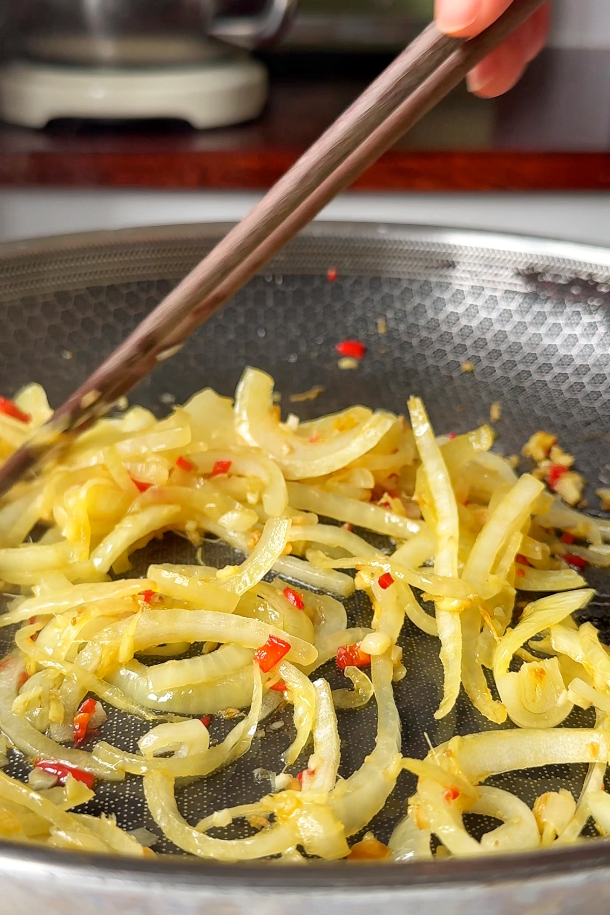 Frying garlic, onion, and chillies.