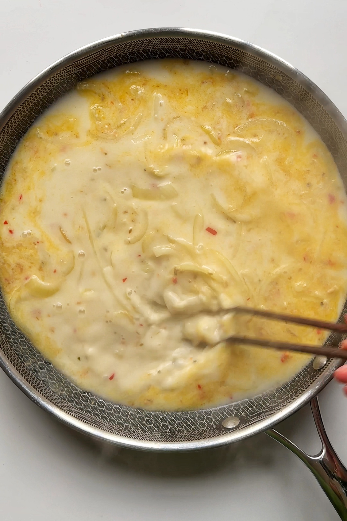 Coconut spicy sauce in black frying pan.