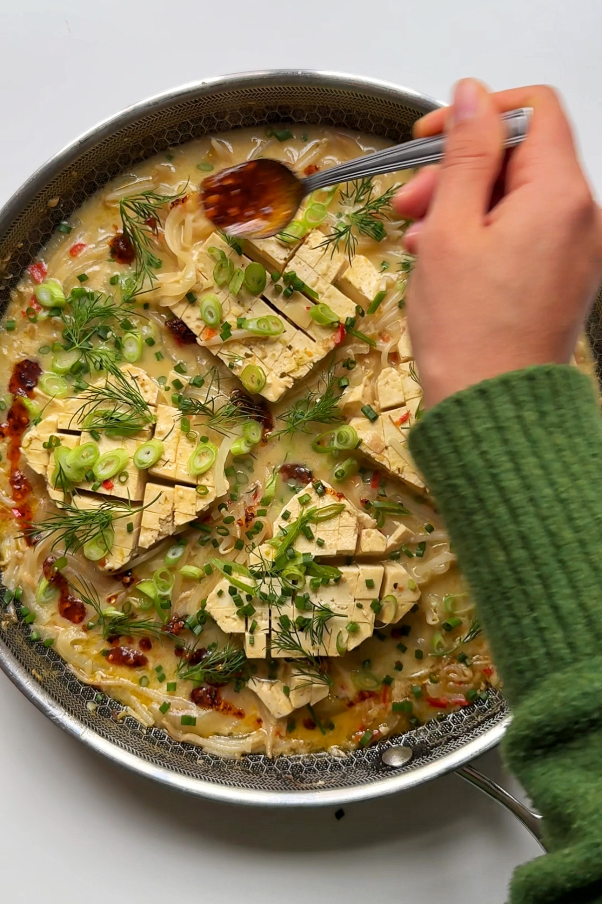Topping the extra firm tofu coconut sauce.