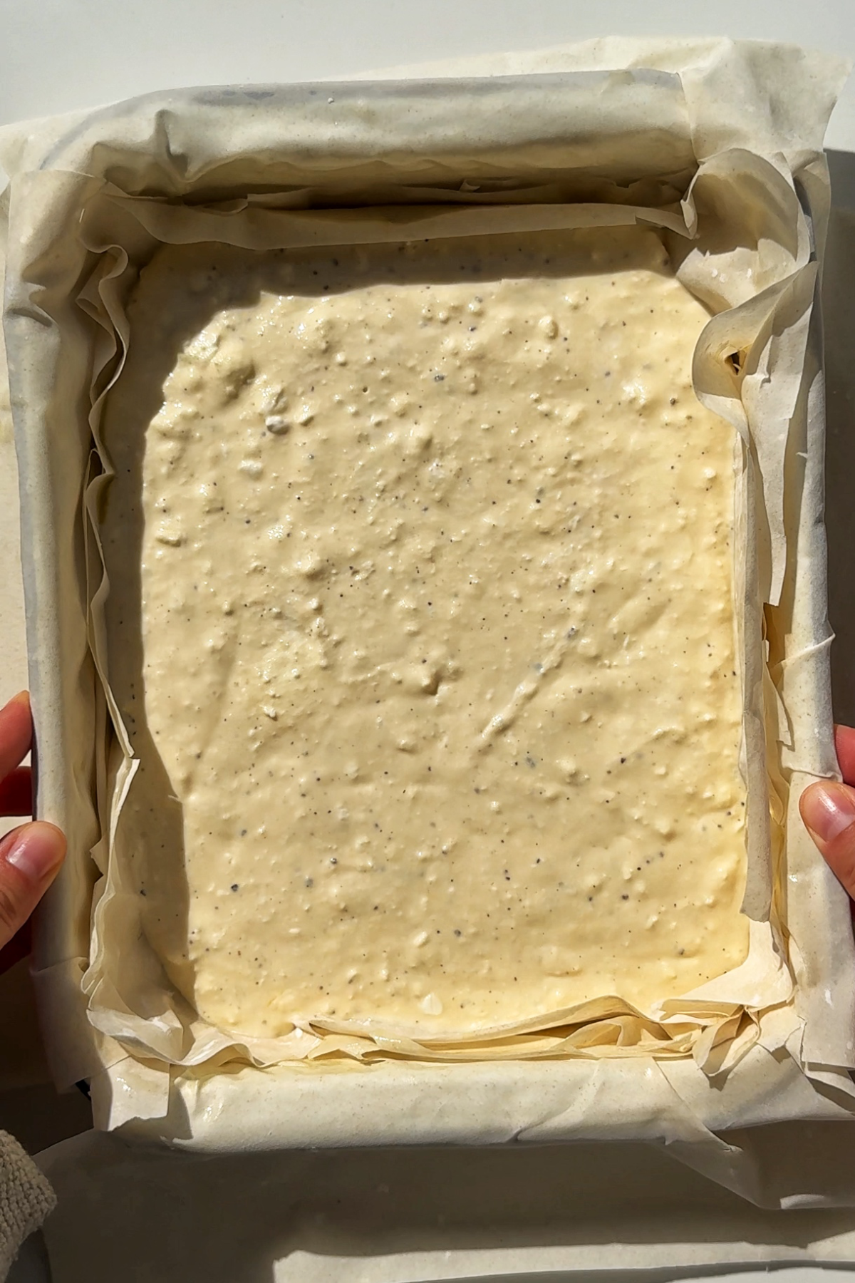 Cheese filling into the tiropita pie.