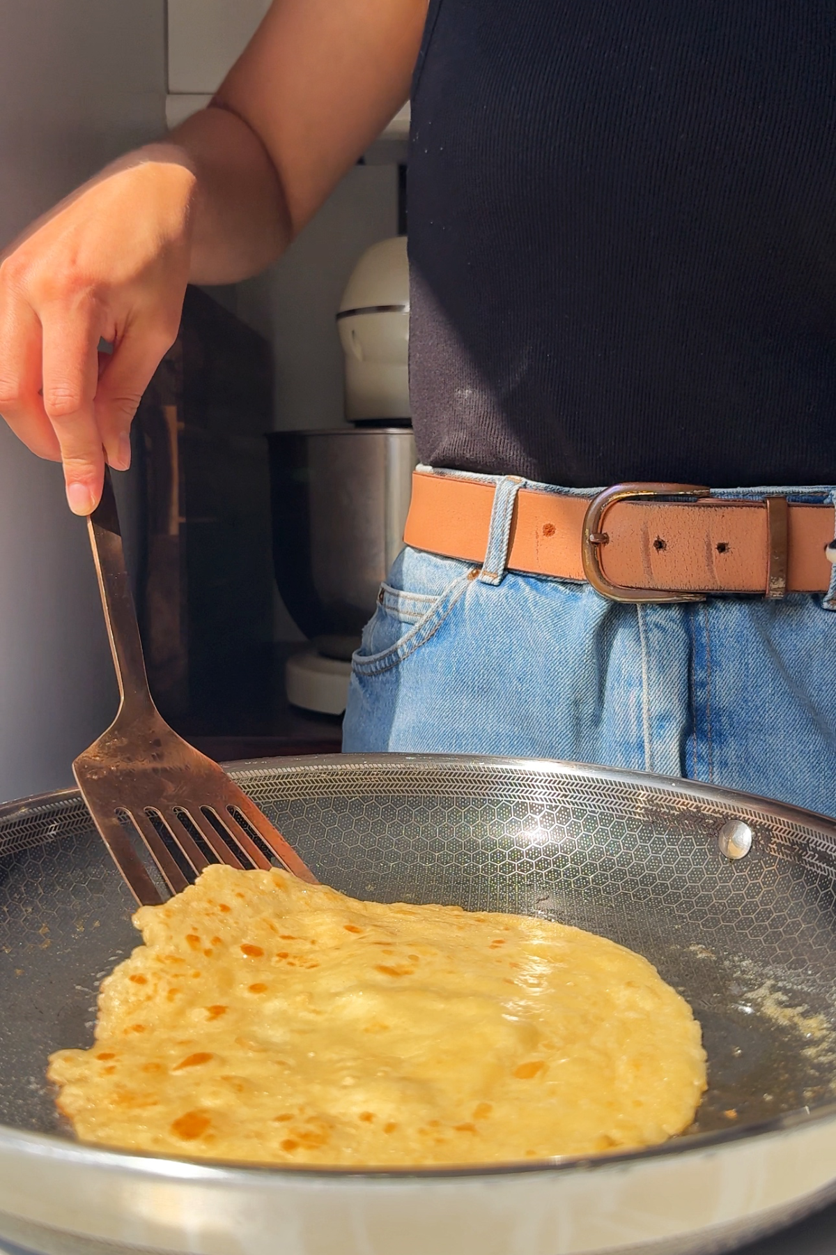 Flipping pancakes in a frying pan.