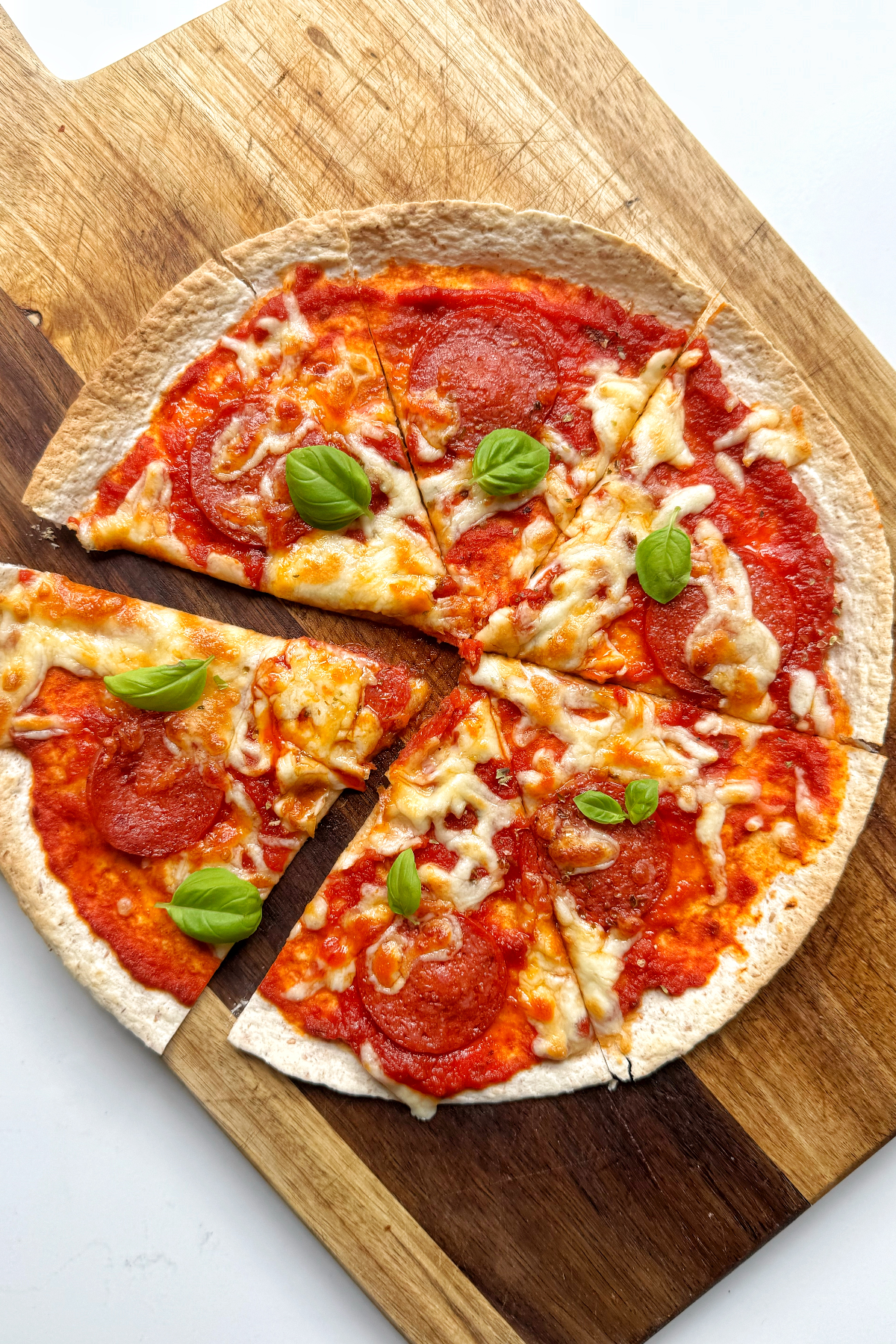 pizza wrap on wooden chopping board.