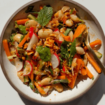butter bean salad in a white bowl.