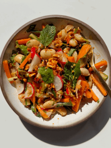 butter bean salad in a white bowl.