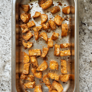 ciabatta croutons in metal tray.