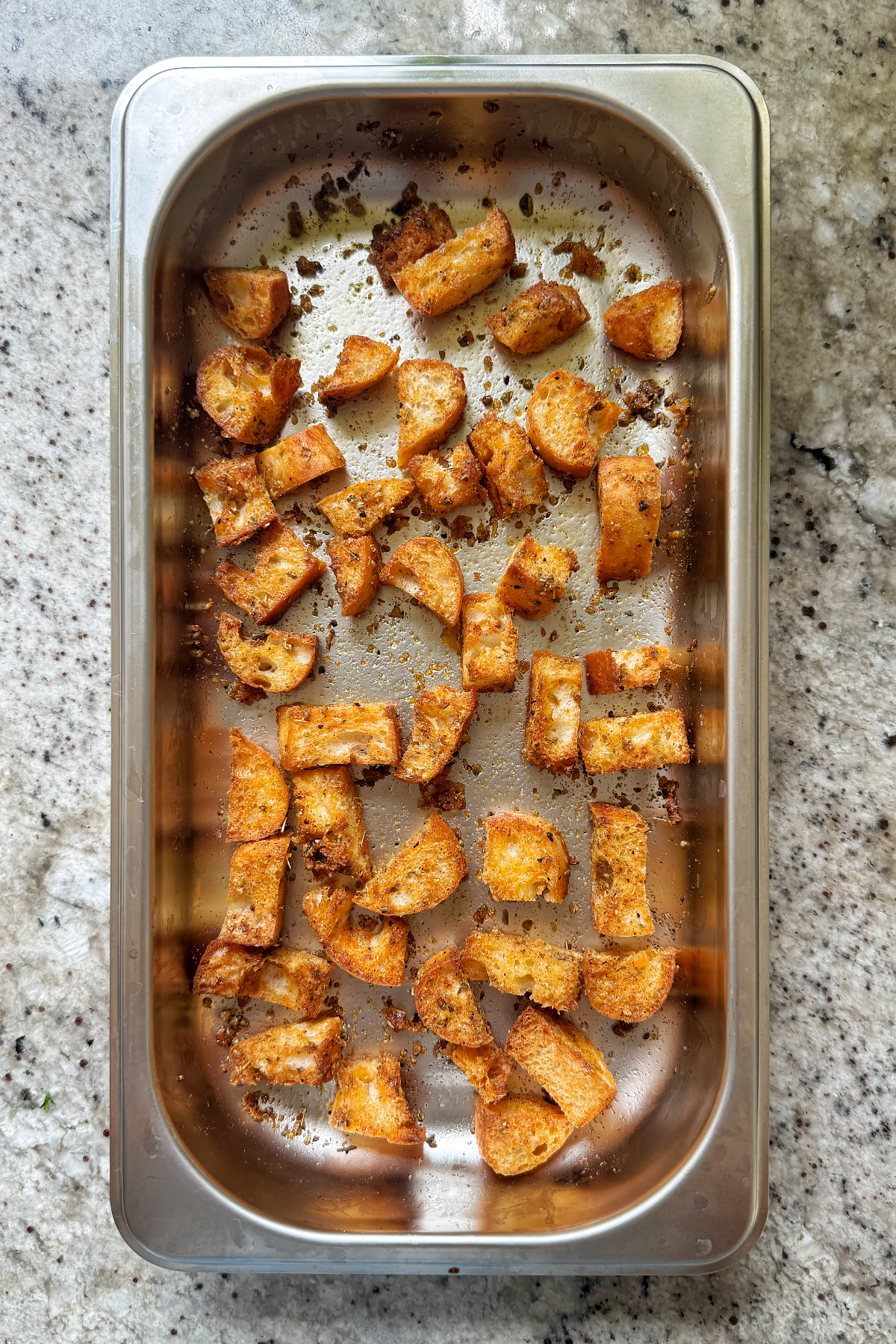 ciabatta croutons in metal tray.
