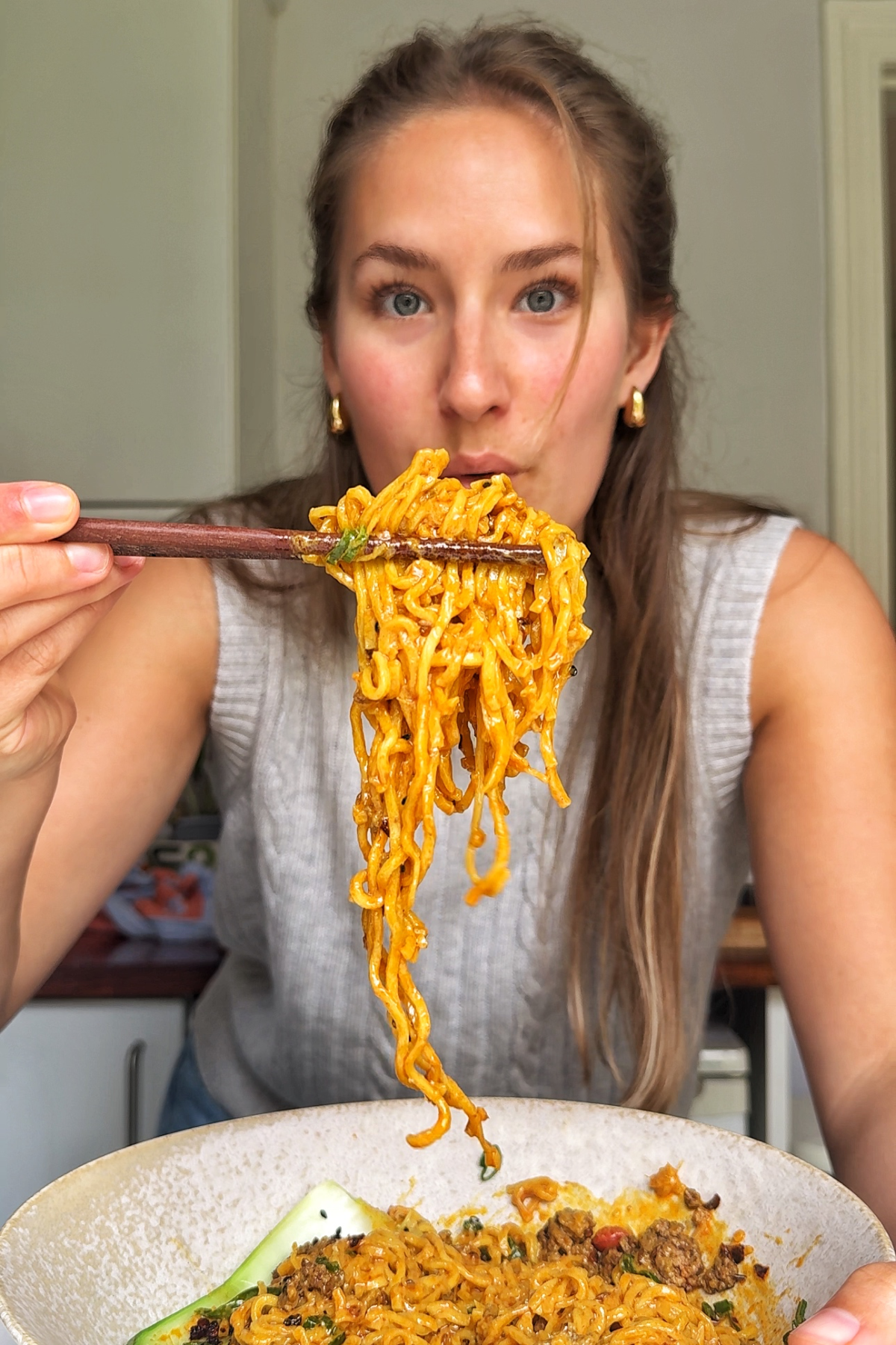 Emily Roz eating curry noodles.