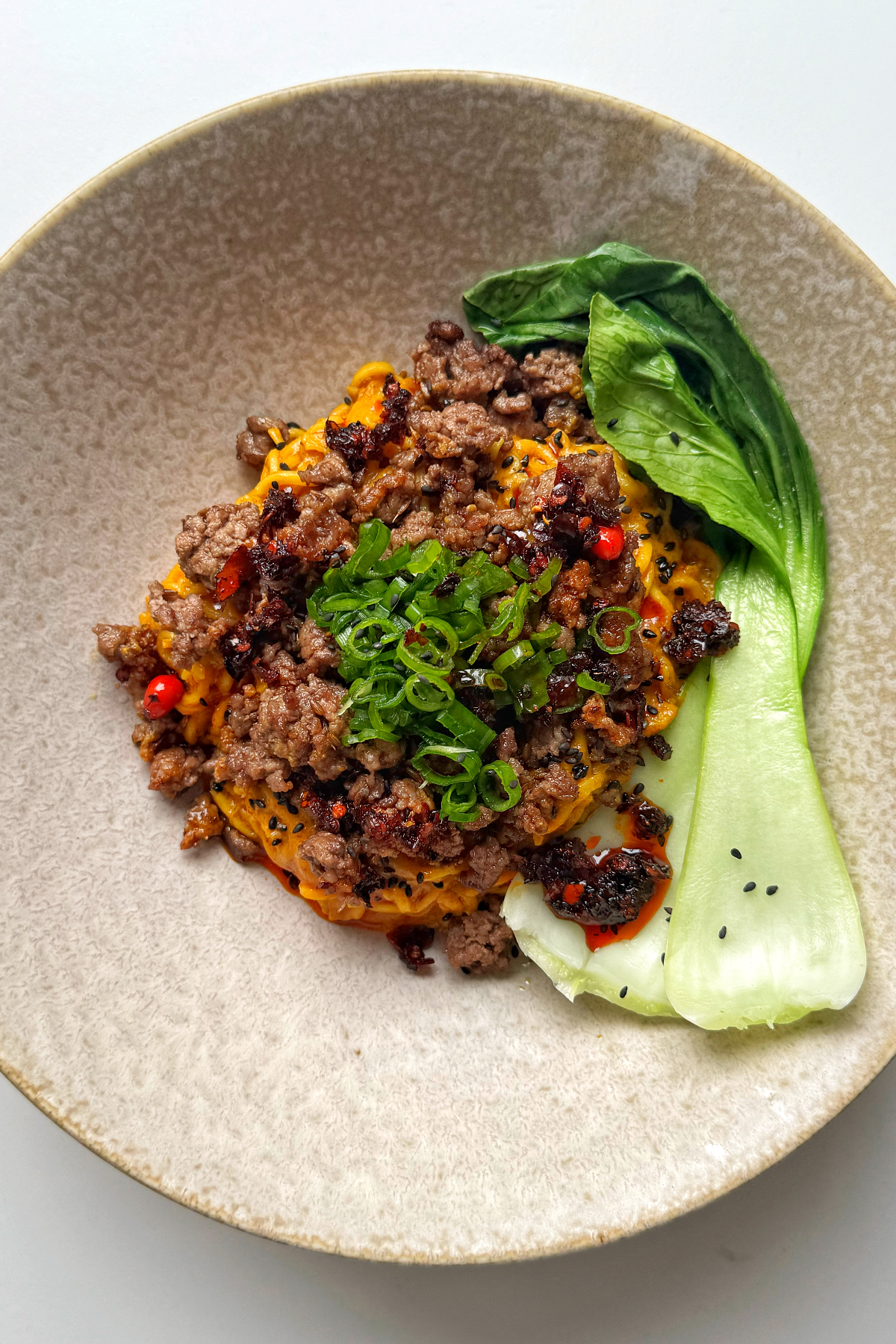 curry noodles with crispy ground beef pak choi and scallions.