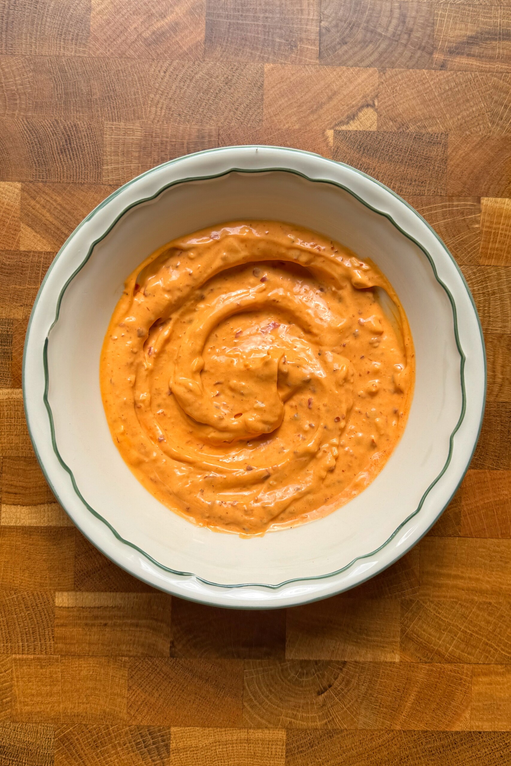 harissa aioli in a white bowl.