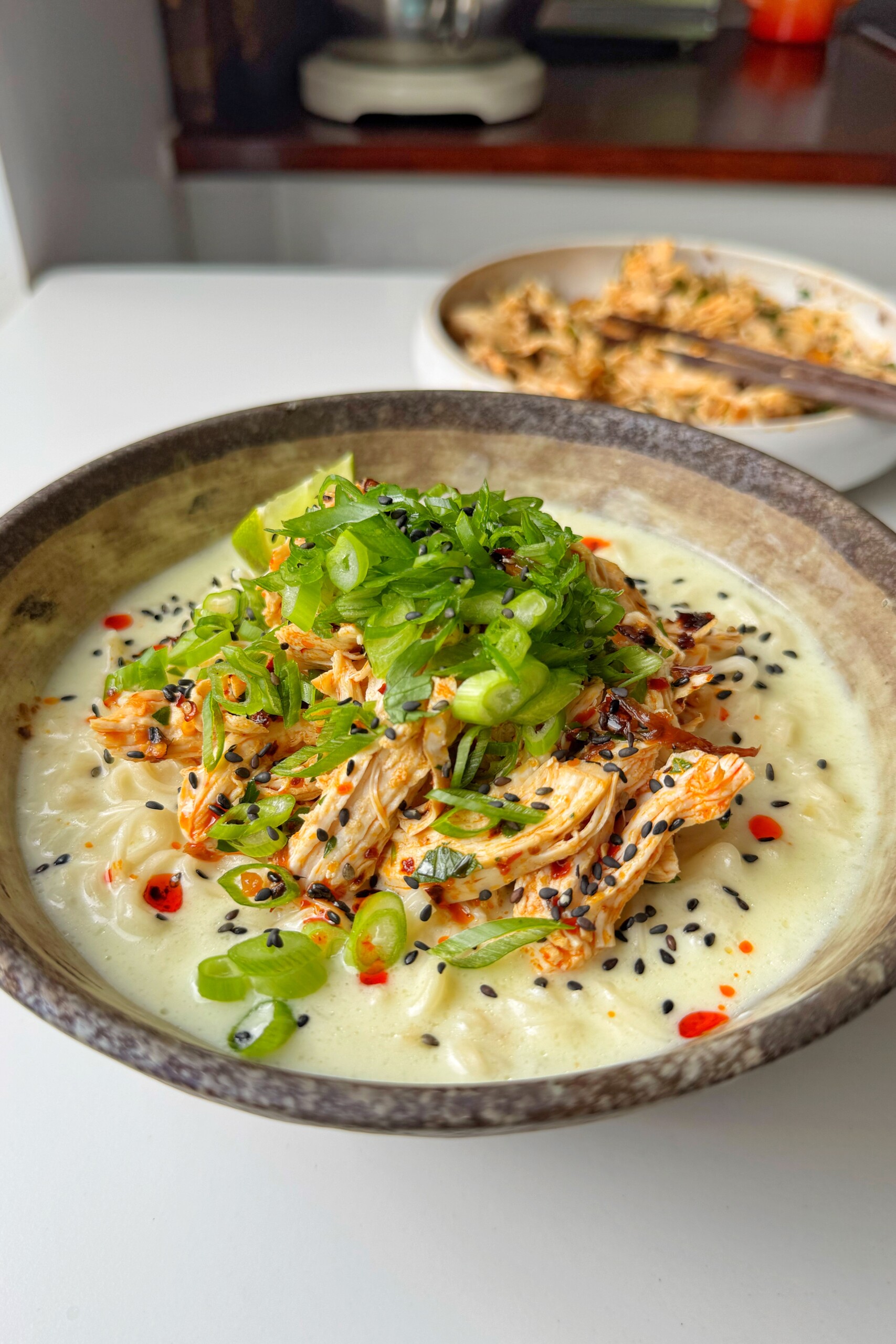 Bowl of lime and coconut chicken noodles.