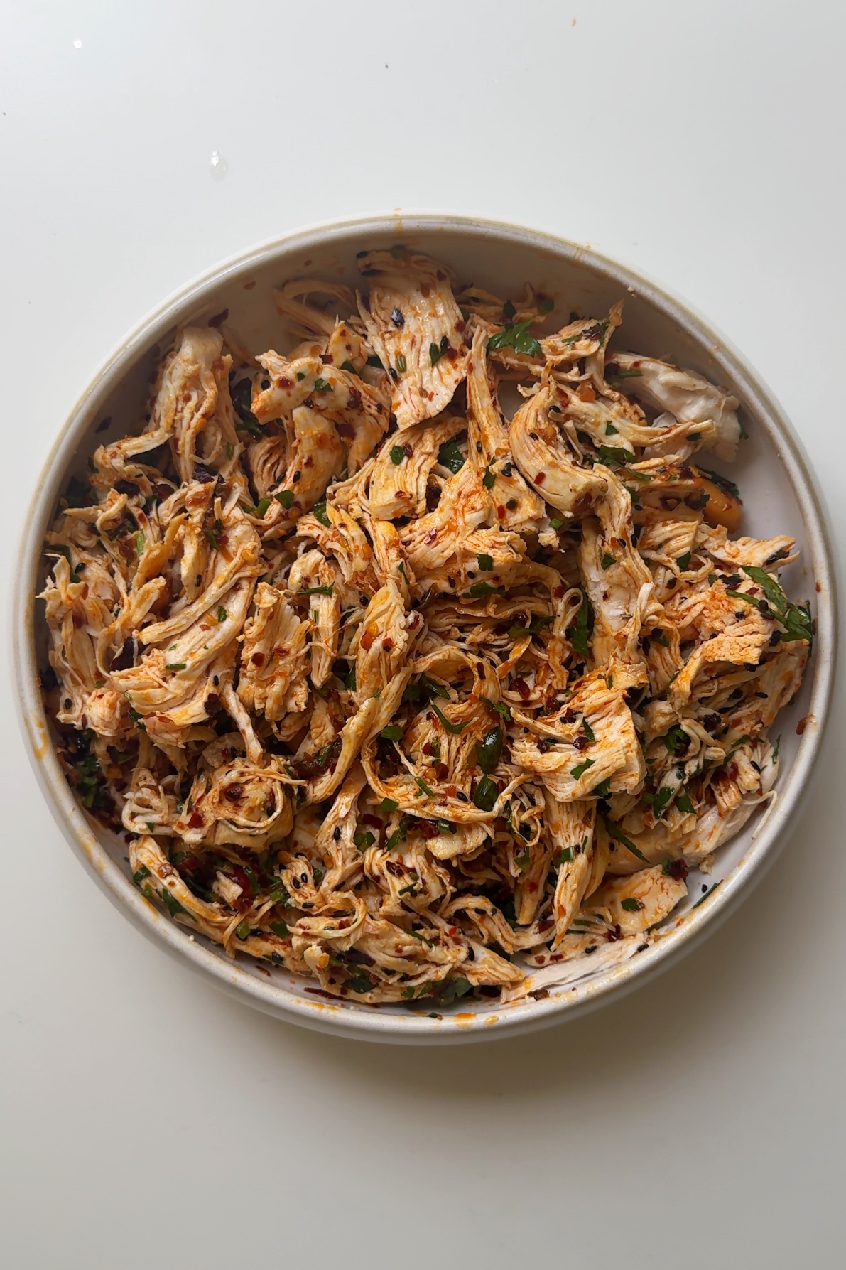 Shredded chicken with chili oil and parsley.