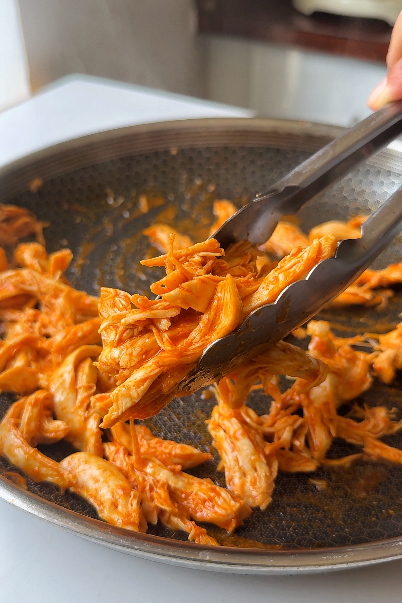 Frying chicken in pan.