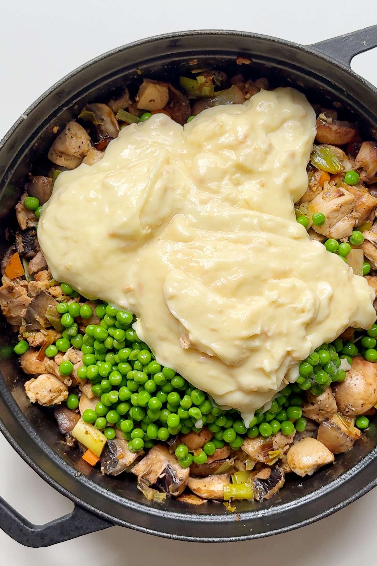 Adding cream of chicken soup into the chicken pot pie mixture.