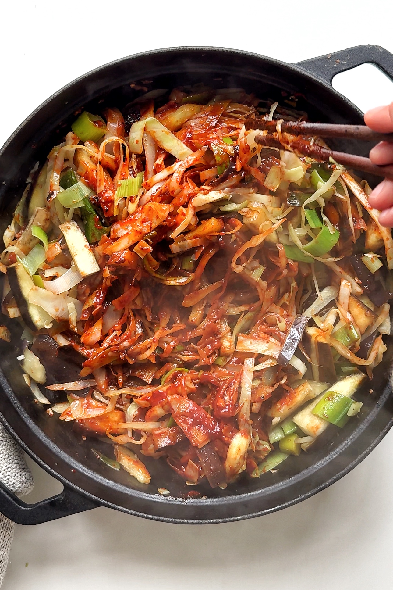 black pan with cabbage and gochujang sauce.